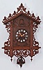 Black Forest, Germany, railway house cuckoo clock, 3 day, time and strike with calling cuckoo bird, spring driven two train movement with a single fusee on the strike train in a softwood case with hardwood carvings, white enamel cartouche numerals on the dial, and bone hands.