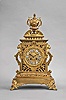 France, mantel clock, 8 day, time and strike, spring driven pendule de Paris movement in a cast brass Renaissance Revival case with gilt accents, front feet in the form of foliate faces, lion masks on either side and on top urn finial, dial with white enamel cartouches and blued steel hands.