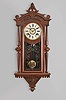 F. Kroeber Clock Co., New York, "Regulator No. 30" wall hanging clock with an E. N. Welch spring driven, 8 day, time and strike movement in a walnut case with burl accents.