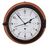 Chelsea Clock Co., Boston, Mass., "12E Deck & Engine Room Clock", 8 day, time only, spring driven movement with jeweled lever escapement and center seconds in a black phenolic case with hinged bezel, 8.5 inch white dial signed "U.S. Government" with 12 and 24 hour markers, blued steel spade hands, all mounted to a molded hardwood backer, movement serial number 871004, c1992.