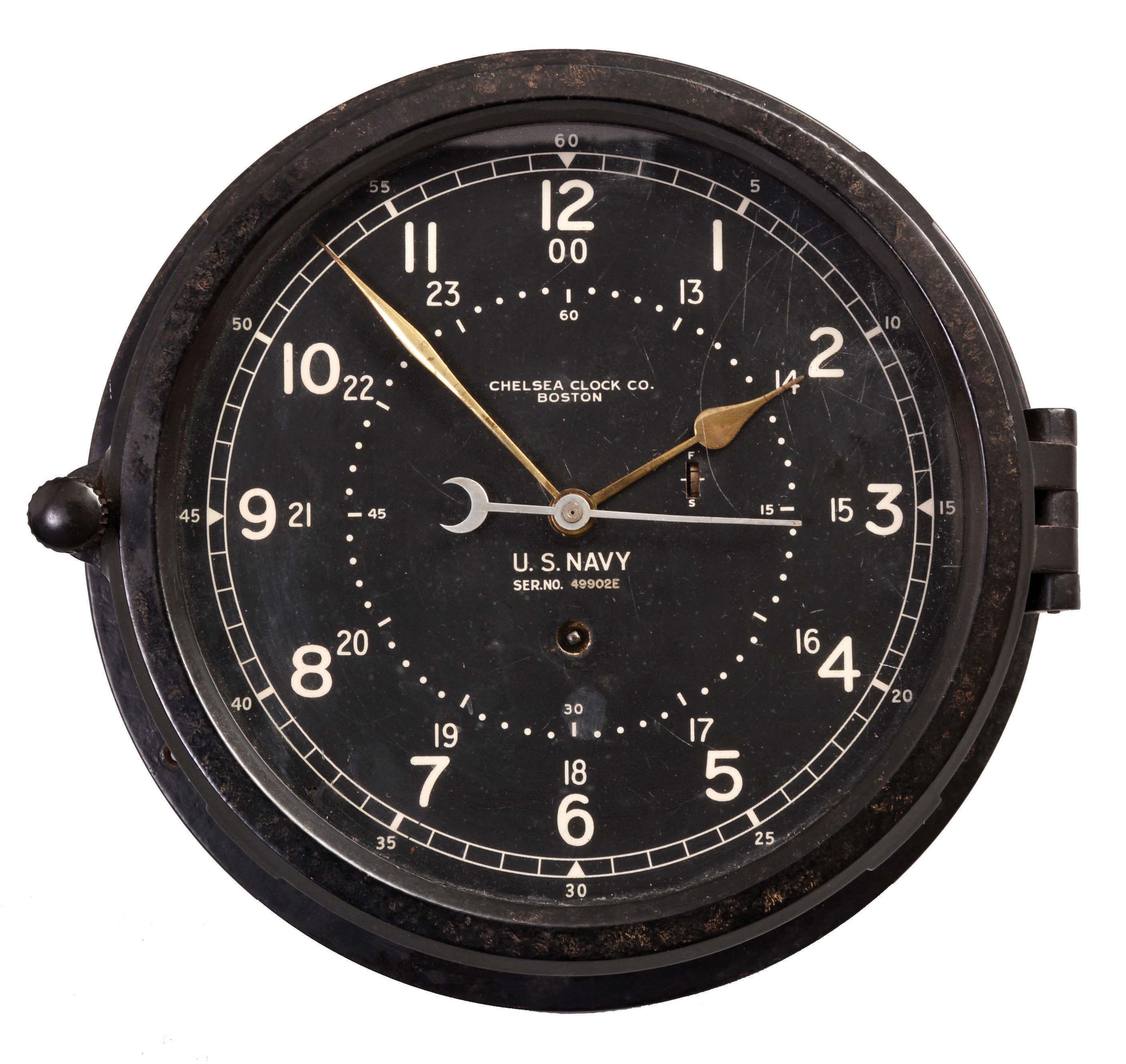 Chelsea Clock Co., Boston, Mass., "11E Deck and Engine Room" timepiece, 8 day, time only, spring driven, jeweled movement with gold hands, center seconds, in a black phenolic case with 8.5 inch black dial with 12/24 numerals, dial reading "U.S. NAVY, SER. NO. 49902E ". — Antique Clocks Price Guide