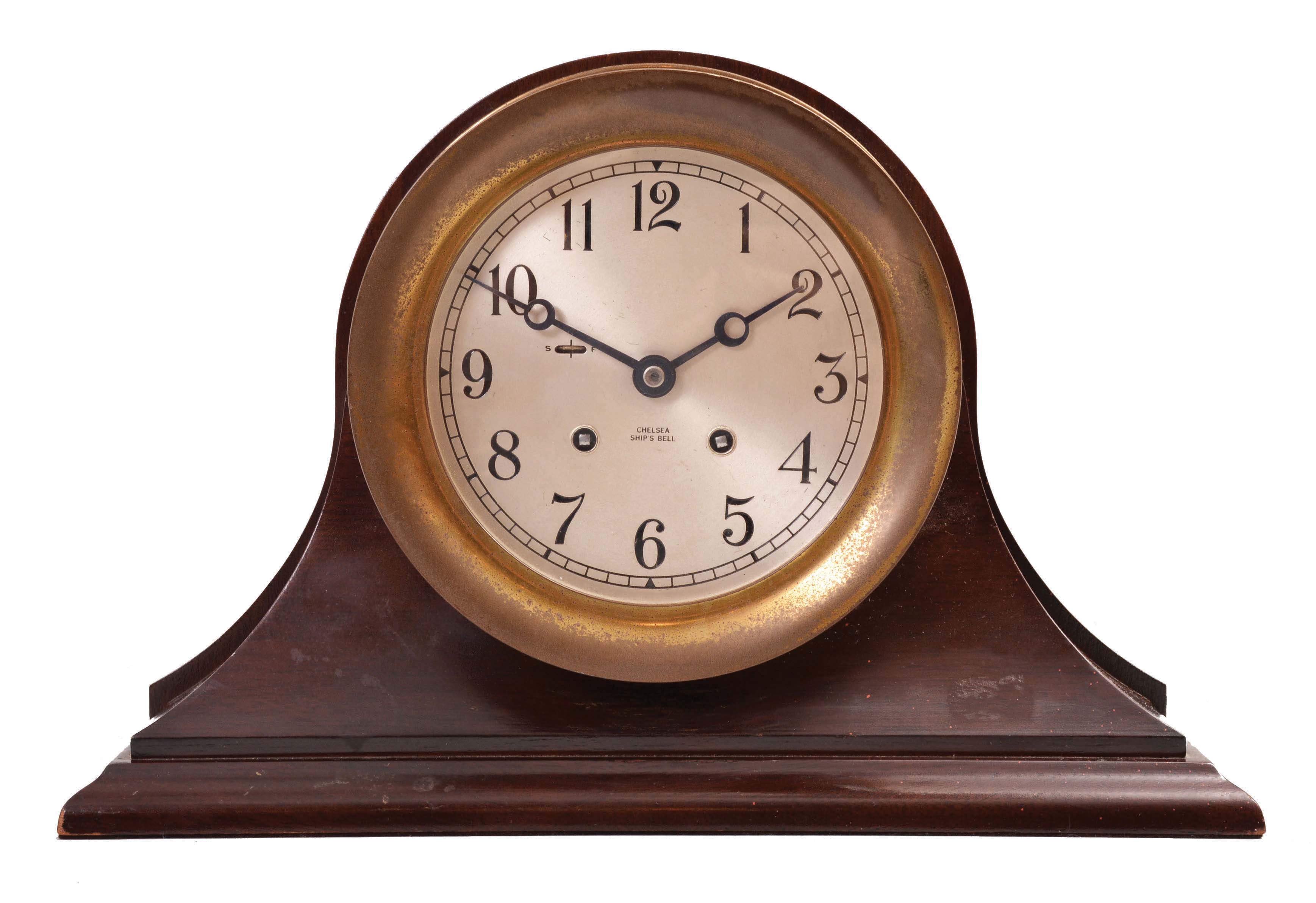 Chelsea Clock Co., Boston, Mass., ship's clock, 8 day, time and ship's strike, jeweled movement with lever escapement in a brass case with 5.5 inch silvered dial and blued steel Breguet hands, all in a mahogany cradle. — Antique Clocks Price Guide
