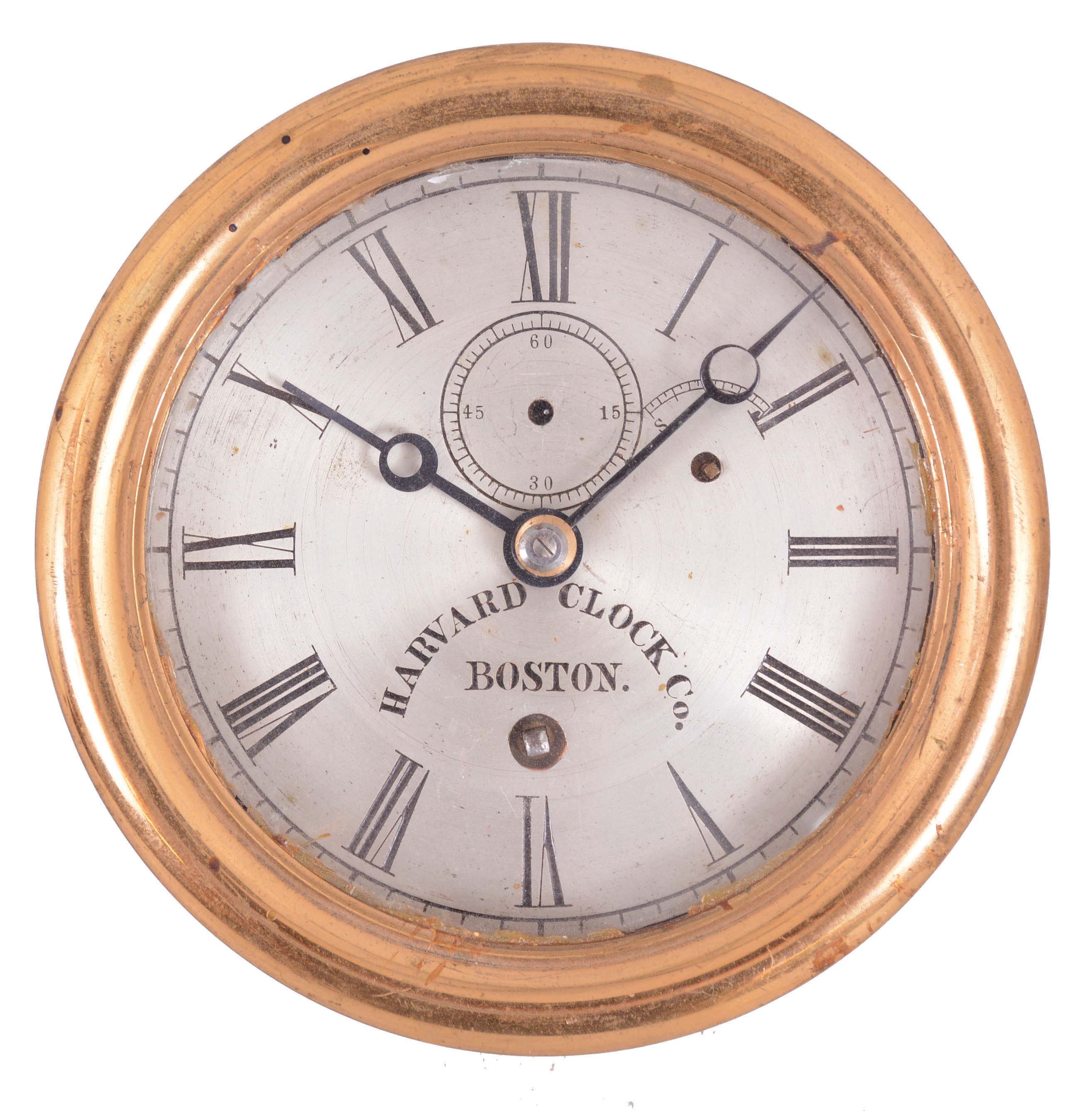 Harvard Clock Co., Boston, with movement signed by the Boston Clock Co., marine timepiece, 8 day, time only, spring-driven balance wheel movement in a brass case with hinged bezel. The movement is also stamped with the important Dec. 28, 1880 patent date and serial number 1947. It seems likely that the Boston Clock Co. may have been using up dials and cases from its predecessor the Harvard Clock Company. — Antique Clocks Price Guide