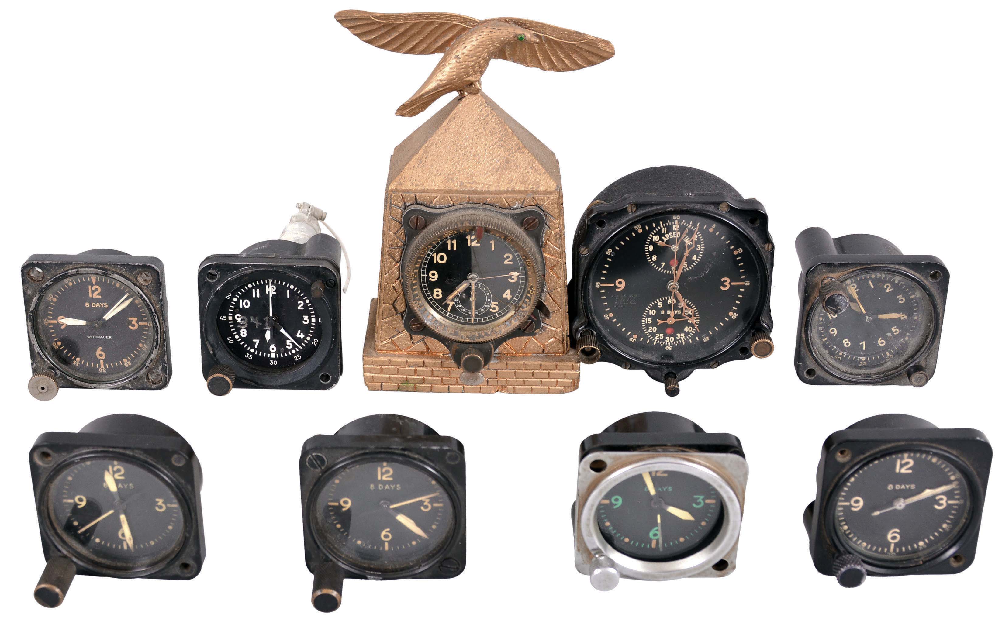 Clocks- 9 (Nine) Aircraft Clocks: Small clocks designed for aircraft instrument panels by makers including Jaeger, Junghans, Waltham, Elgin, Wittnauer, an others. The Junghans is mounted in a carved gold case featuring a bird. — Antique Clocks Price Guide