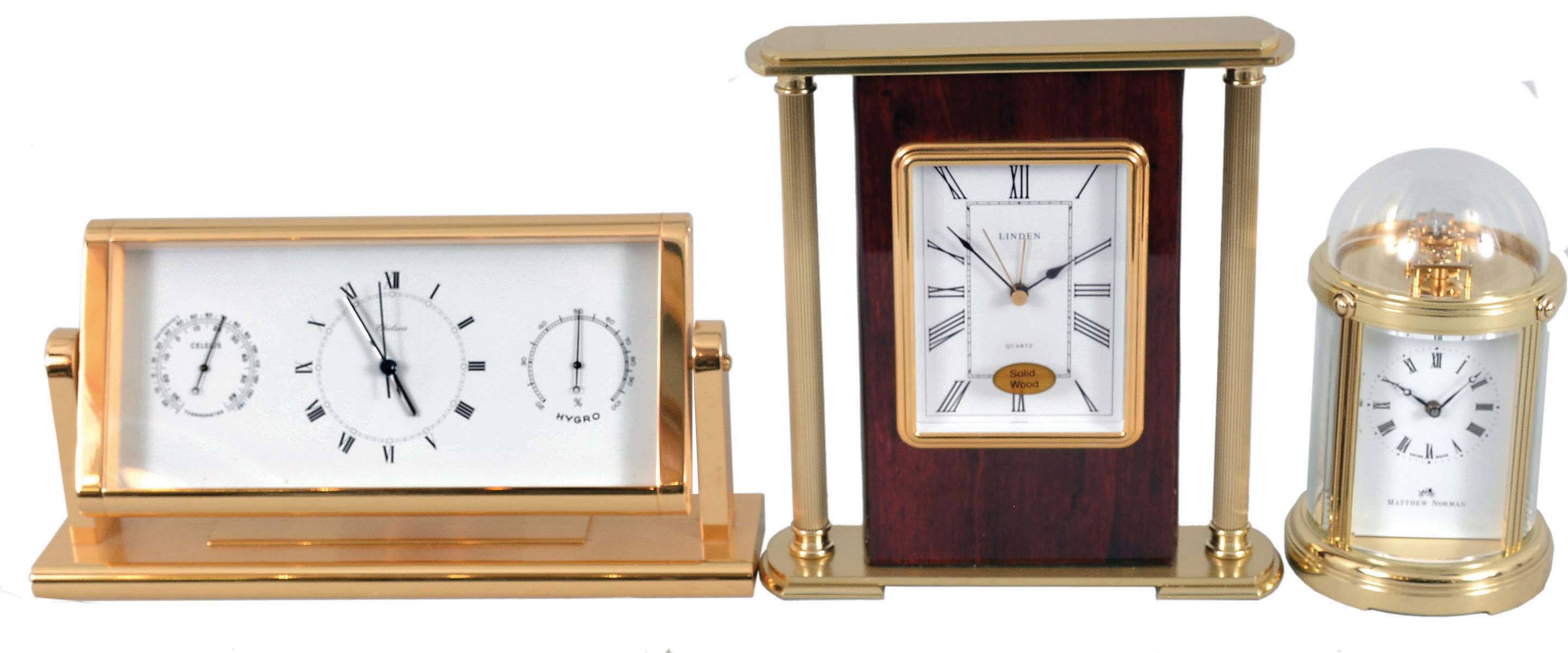 Clocks- 3 (Three) Fancy Modern Desk: (1) Mathew Norman, Switzerland, carriage clock, 8 day, time only, spring driven movement with visible balance wheel movement in a highly polished brass case with beveled glass sides and dome top; (2) Chelsea Clock Co., Boston, quartz clock with thermometer and hygrometer in polished brass case; (3) Linden, North Smithfield, RI, quartz table clock in a wood and metal case. — Antique Clocks Price Guide