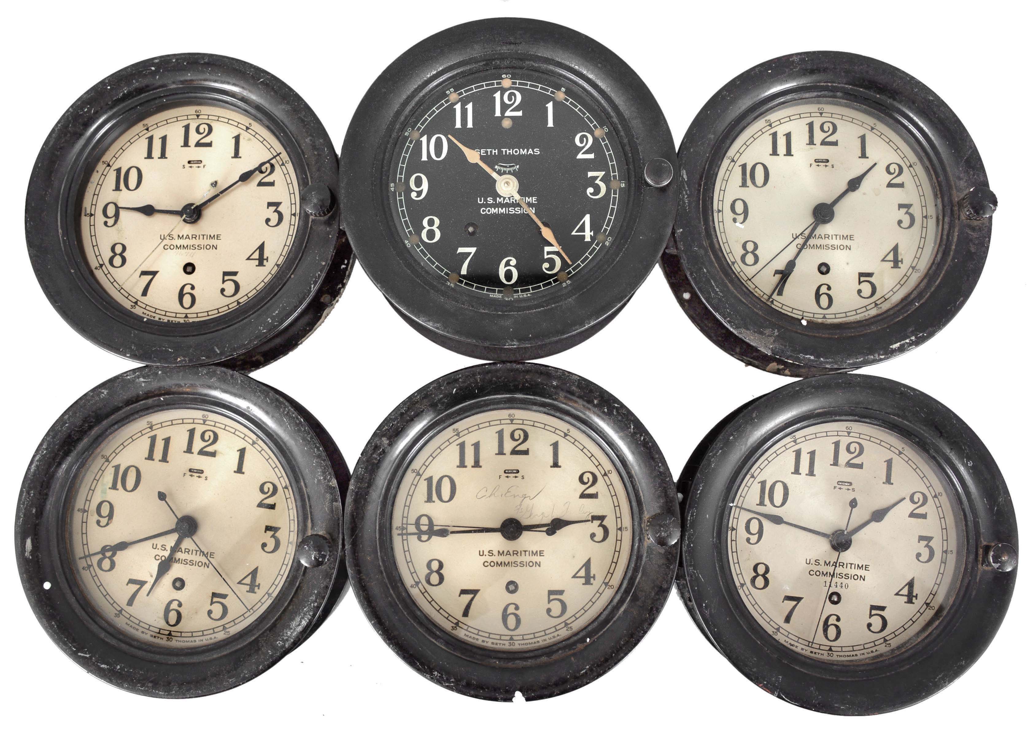 Clocks- 6 (Six) Seth Thomas Marine Clocks: Seth Thomas Clock Co., Thomaston, Conn., for U.S. Maritime Commission, five being 8 day, time only wardroom or engine room clocks with center seconds on 5.5 inch silvered dials in black phenolic cases with hinged bezels, the last being a time and ship's stirke clock in a black phenolic case with black dial. — Antique Clocks Price Guide