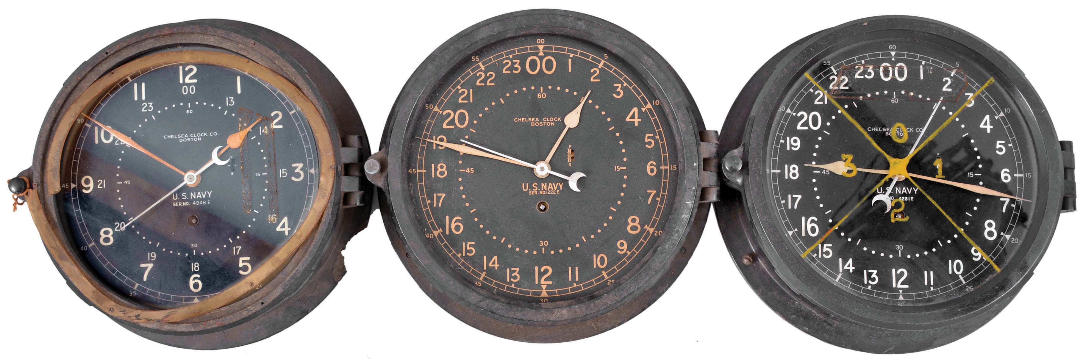 Clocks- 6 (Six) Chelsea Engine Room: Chelsea Clock Co., Boston, for U.S. Navy, "12E Deck &amp; Engine Room Clock", 8 day, time only, spring-driven balance wheel movement in black phenolic cases with hinged bezels, all but one with 8.5 inch black dial, 12 and 24 hour variants, and center seconds. — Antique Clocks Price Guide