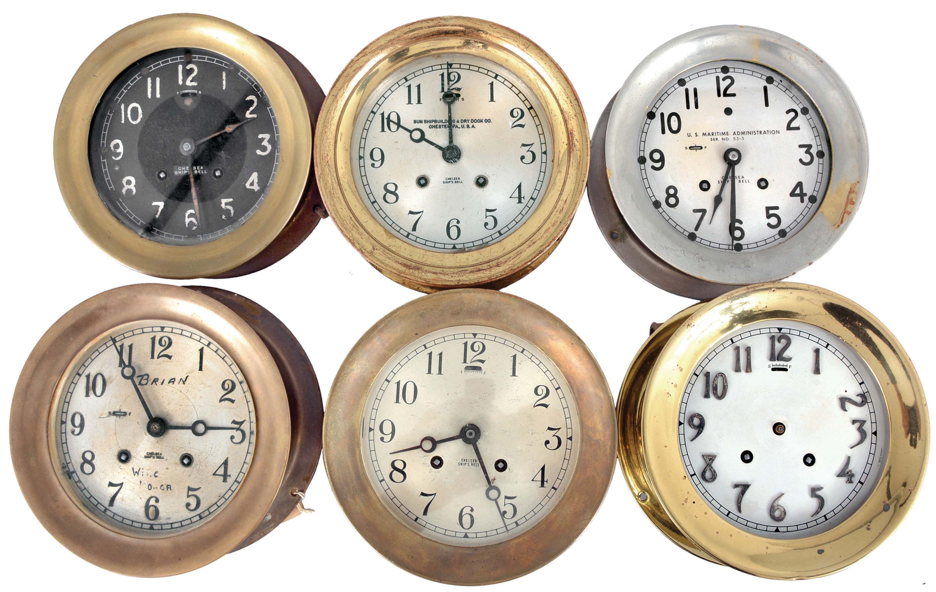 Clocks- 6 (Six) Chelsea Ship's Bell: Chelsea Clock Co., Boston, marine clocks, 8 day, time and ship's strike, spring-driven balance wheel movements in brass or nickel plated cases, two with hinged bezels and four with screw-on bezels, one with a black dial and the rest with 5.5 inch silvered dials, one signed "U.S. Maritime Administration" and another "Sun Shipbuilding &amp; Dry Dock Co. ". — Antique Clocks Price Guide