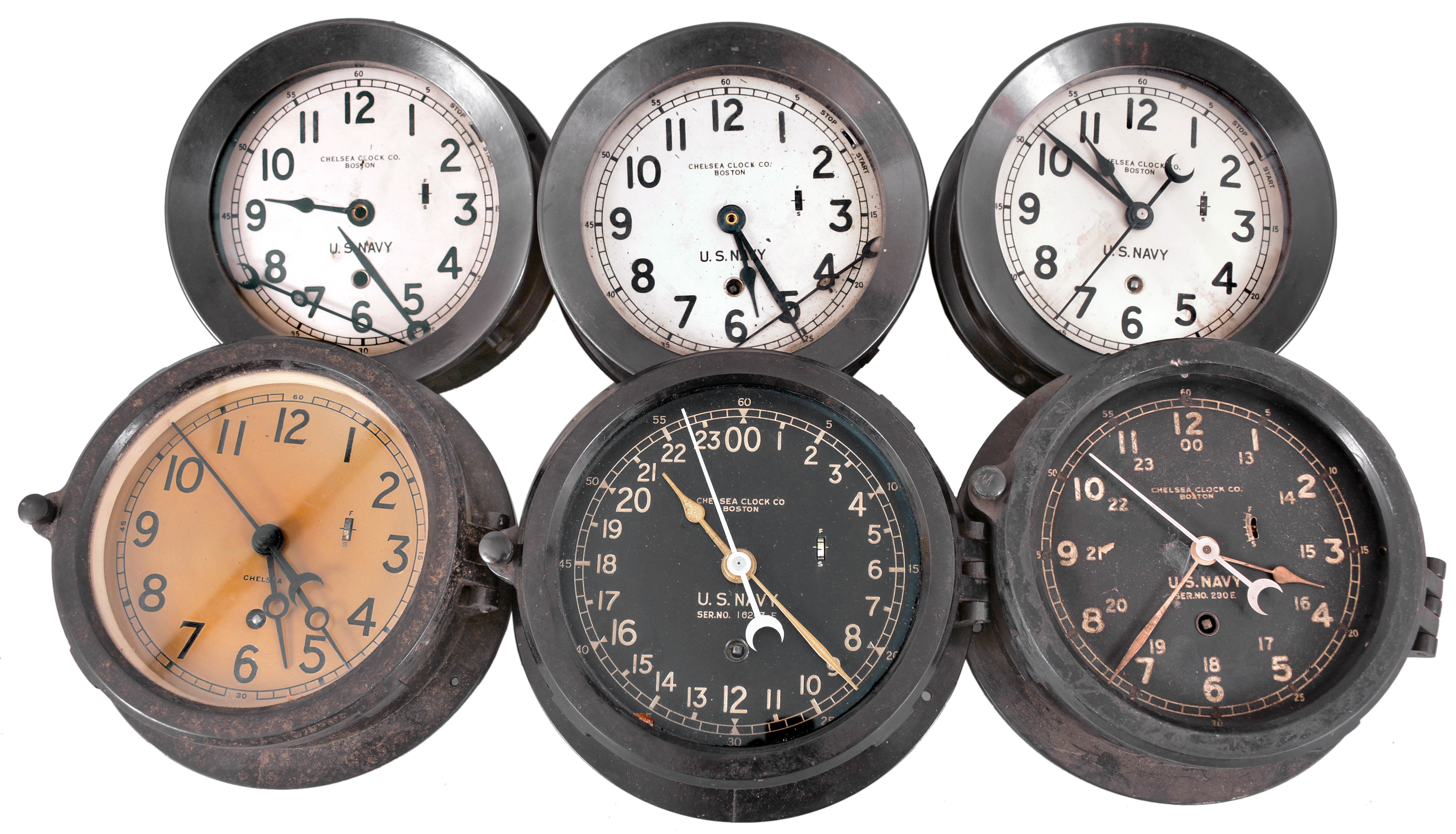 Clocks- 6 (Six) Chelsea Deck or Engine Room: Chelsea Clock Co., Boston, for U.S. Navy, "Deck &amp; Engine Room" clocks, 8 day, time only, spring-driven balance wheel movements in black phenolic cases with hinged bezels, white, black and silvered dials with center seconds. — Antique Clocks Price Guide
