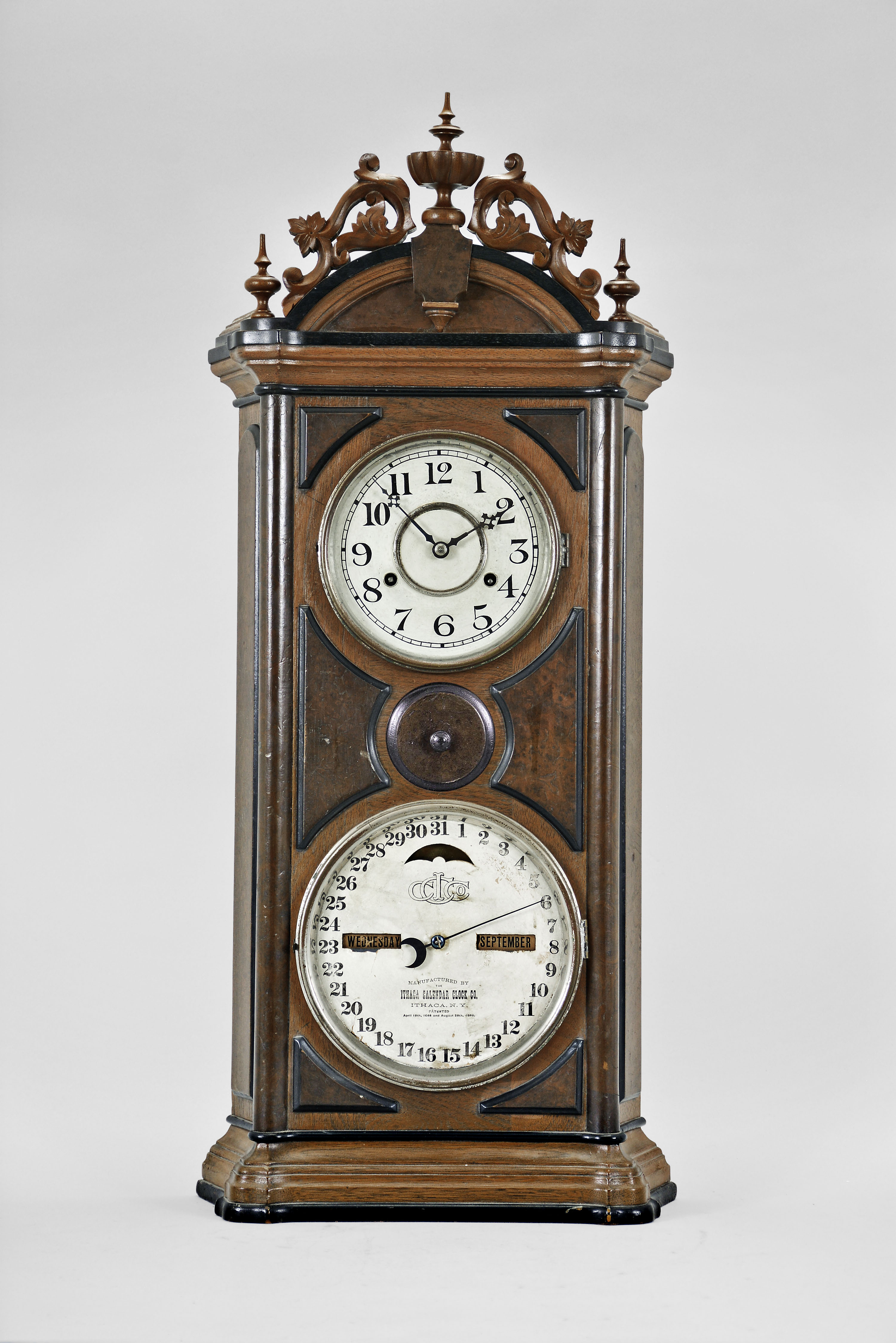 Ithaca Calendar Clock Co., Ithaca, NY, "No. 5 Emerald" shelf clock with a spring driven, 30 day timepiece movement (E. N. Welch) and a H. B. Horton patented perpetual calendar mechanism in a walnut case with burl accents. — Antique Clocks Price Guide