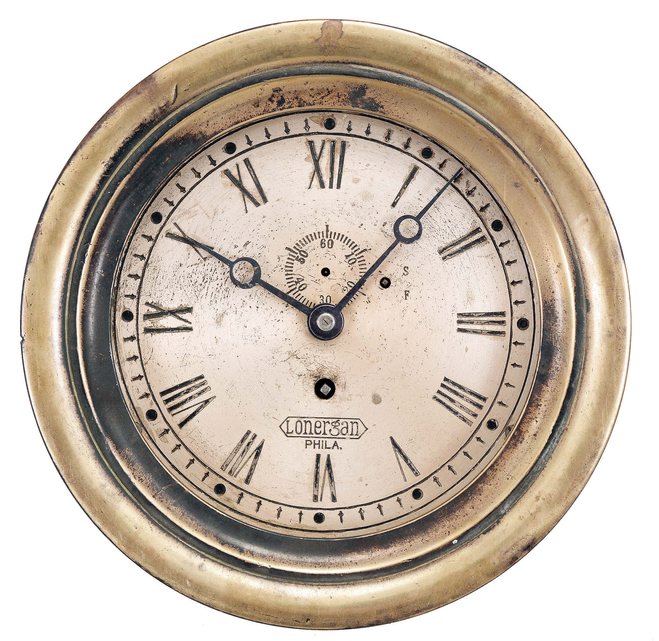 Chelsea Clock Co., Boston, Mass., for J.E. Lonergan, Philadelphia, PA, engine room clock, 8 day, time only, spring driven jeweled balance wheel movment in a heavy brass case with hinged bezel, 6.5 inch silvered dial engraved with "Lonergan / Phila.", subsidiary seconds, and blued steel hands, movement serial number 83412. — Antique Clocks Price Guide