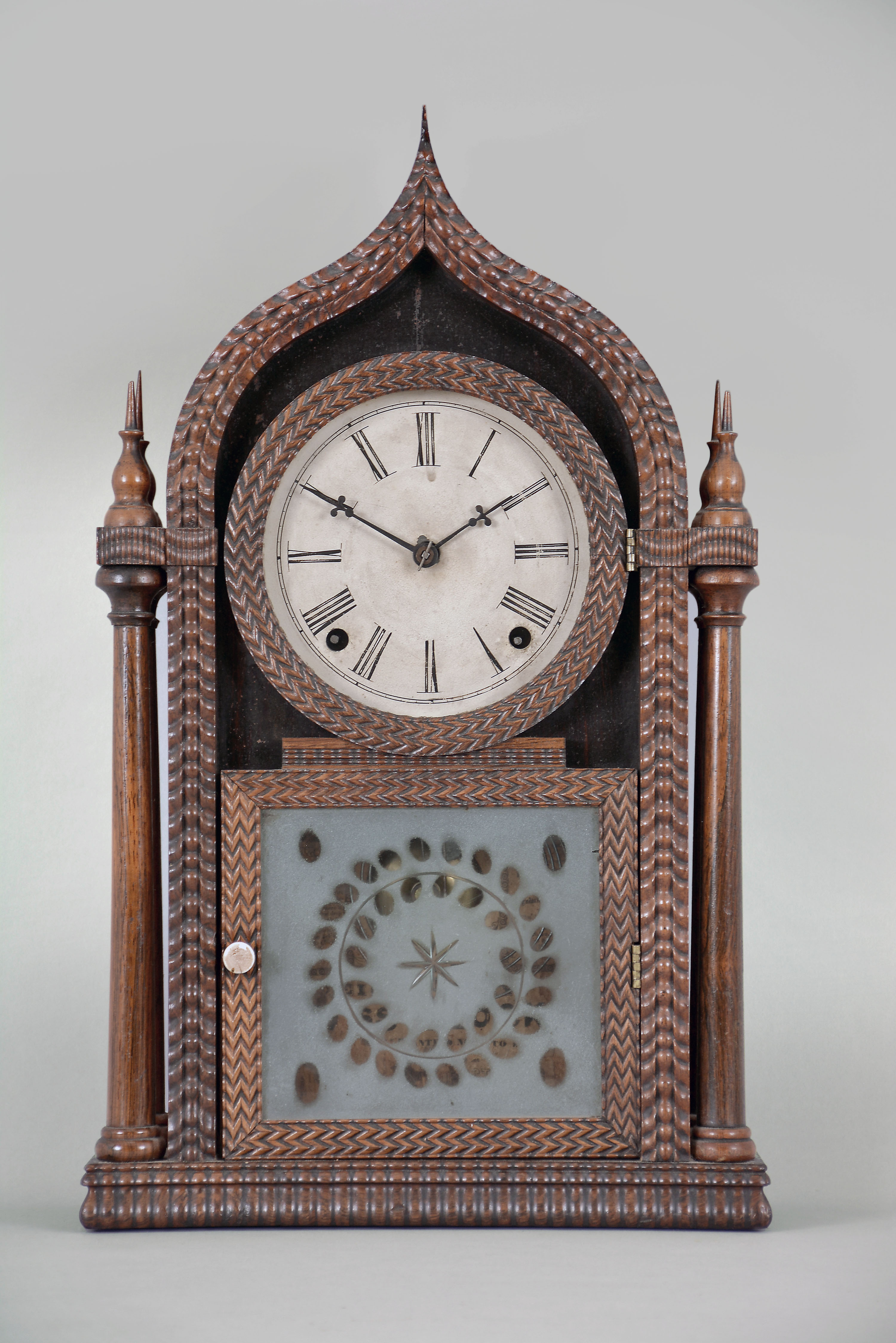 Forestville Manufacturing Co., (J. C. Brown), Bristol, Conn. 8 day, time and strike spring brass movement ripple front 4-column O.G. gothic or onion top shelf clock. — Antique Clocks Price Guide