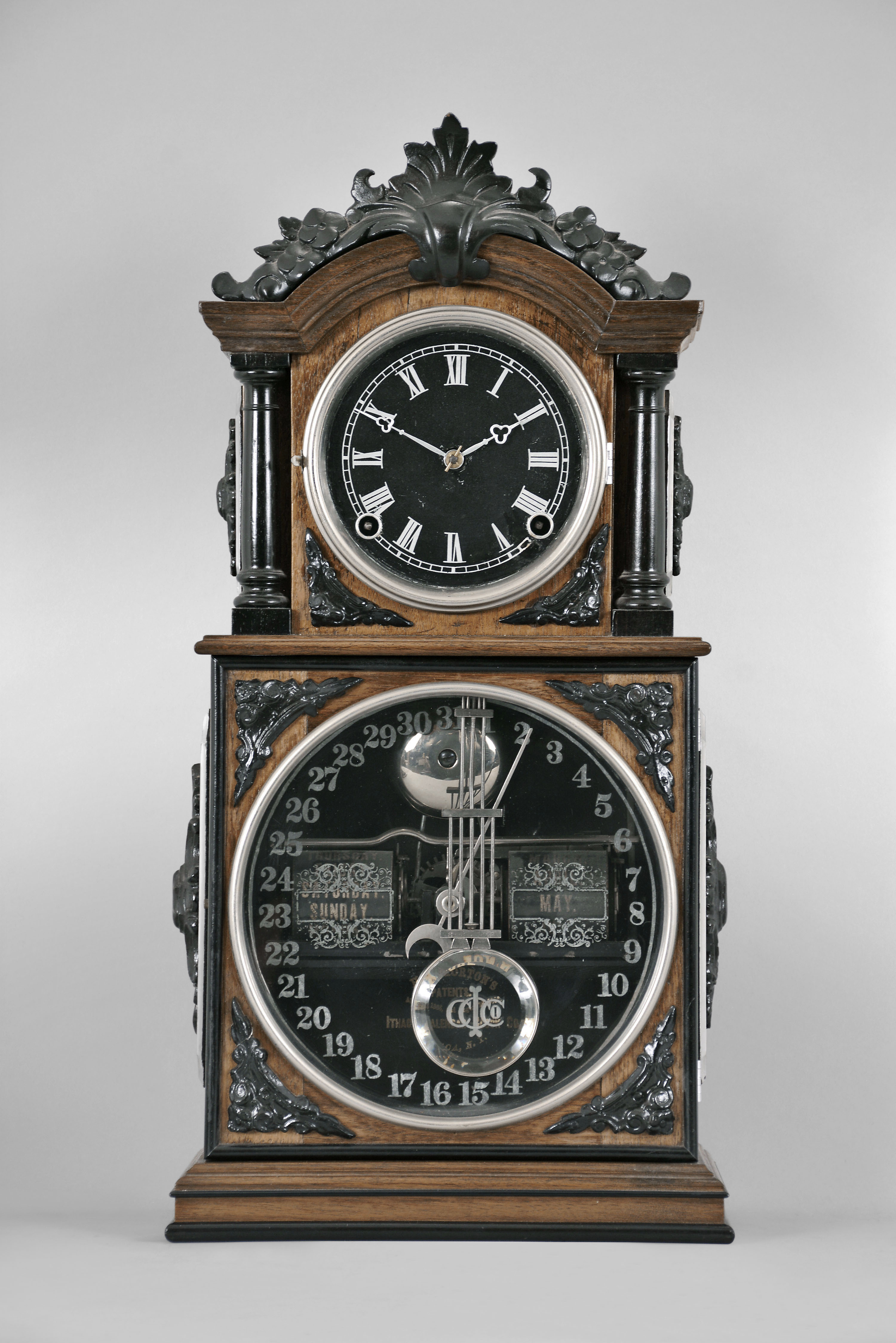 Ithaca Calendar Clock Co., Ithaca, NY, "3 1/2 Parlor" shelf clock with an E. N. Welch spring driven 8 day time and strike movement with a patented perpetual calendar mechanism in a walnut case with ebony trimmings and a customized wall shelf (modern) in the style of the clock case. — Antique Clocks Price Guide