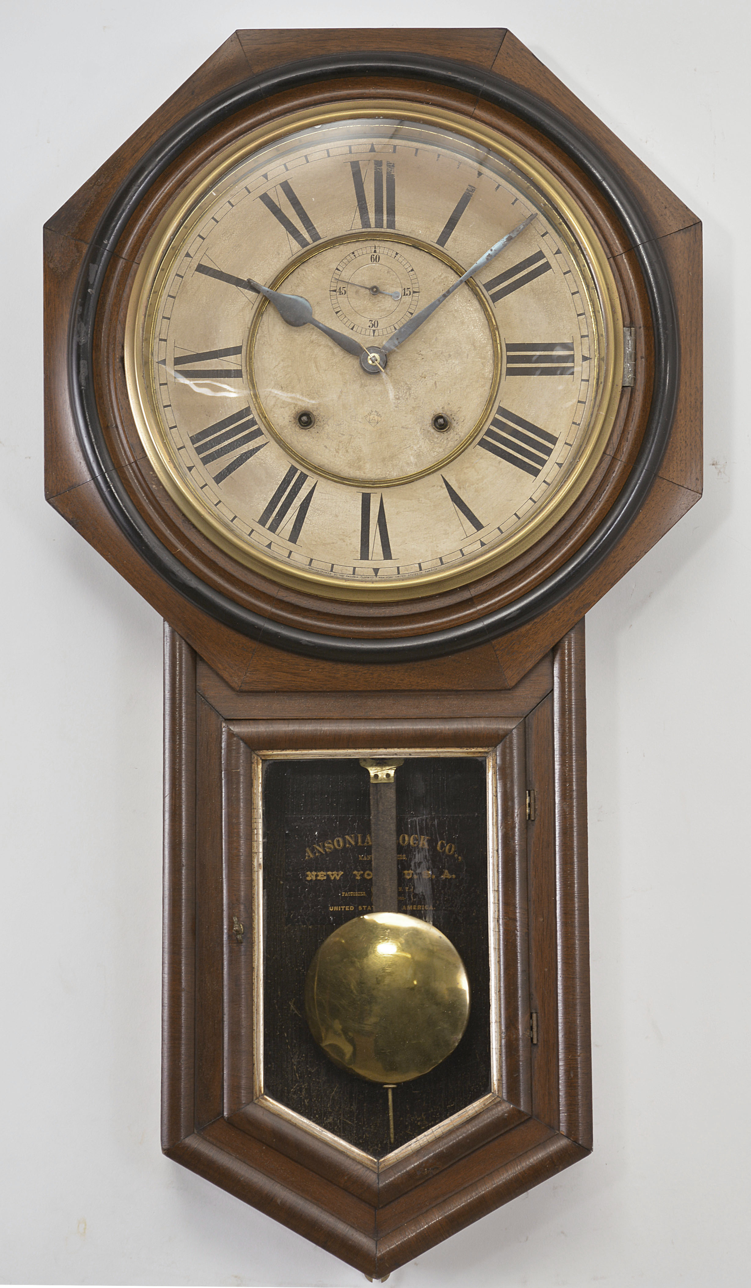 Ansonia Clock Co., New York, "Regulator A" wall clock, 8 day, time and strike, spring driven movement in a walnut case with paper dial with subsidiary seconds and blued steel hands. — Antique Clocks Price Guide