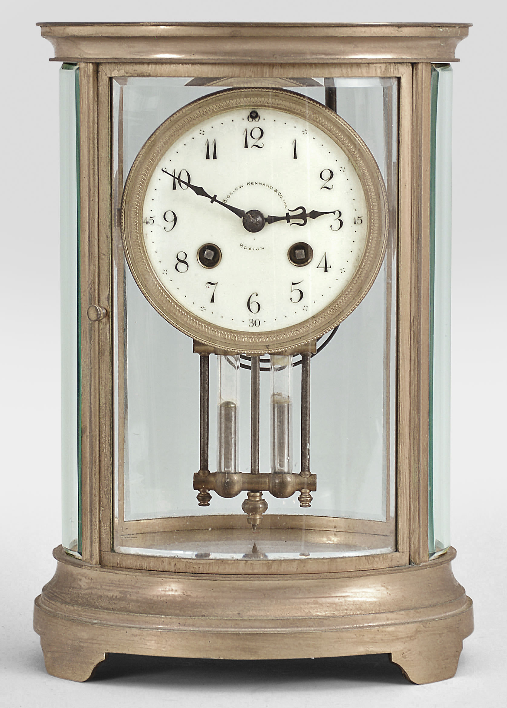 Charles Hour, Paris, for Bigelow, Kennard, &amp; Co., Boston, crystal regulator, 8 day, time and strike, spring driven pendule de Paris movement with Brocot escapement and compensating pendulum in an oval form glazed gilt brass case with cream colored enamel dial with arabic numerals and blued steel hands. — Antique Clocks Price Guide