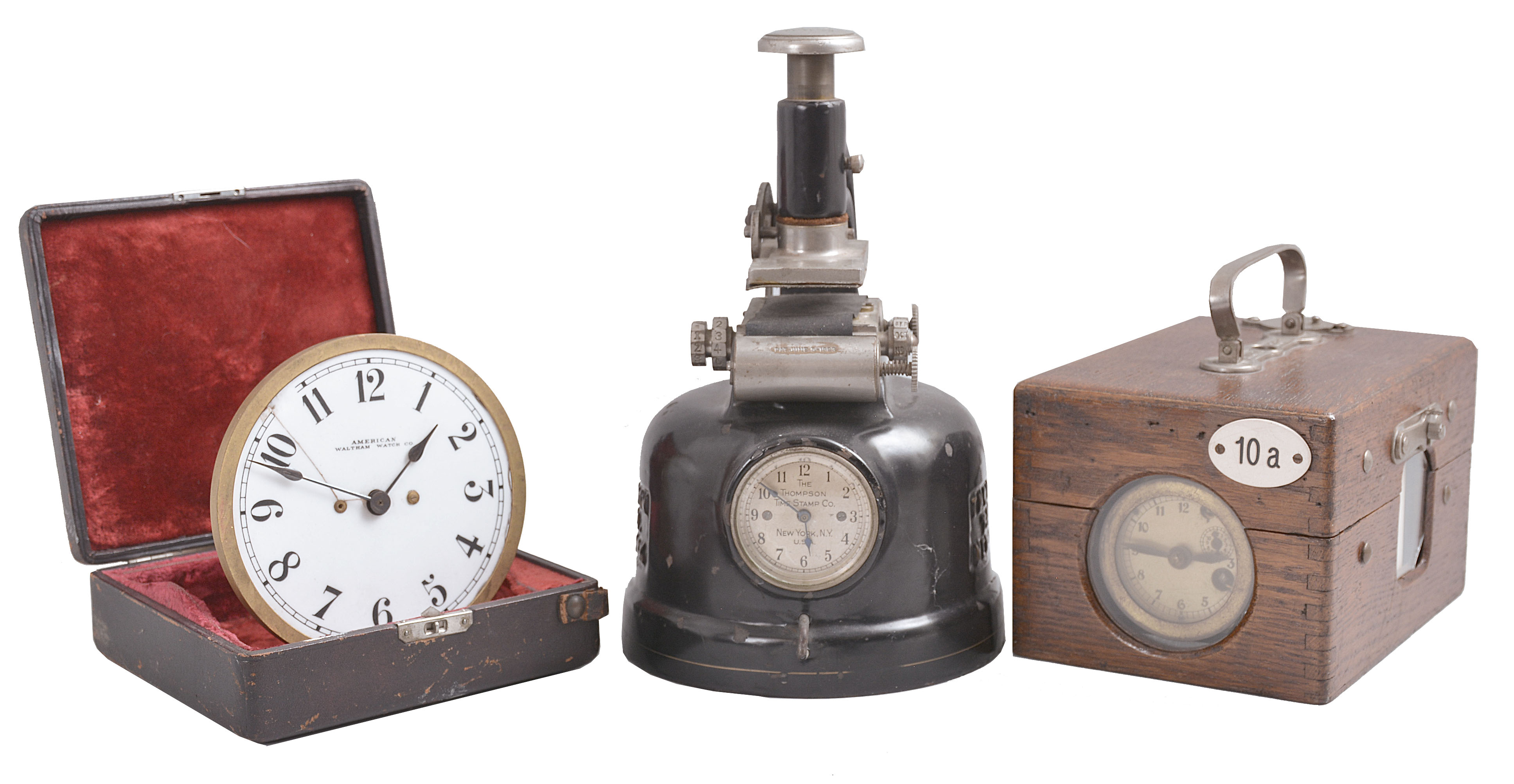 Clocks- 3 (Three) :(1) Jundes, Germany, pigeon timer clock, time and elapsed time recording on paper tape for 18 birds in a finger jointed oak case, c1930; (2) The Thompson Stamp Co., New York, time stamp clock, in cast iron case, c1925; (3) American Waltham Waltham Watch Co., Waltham, Mass., gaslight clock, 30 hour, time only, in a fitted velvet-lined case, c1890. — Antique Clocks Price Guide