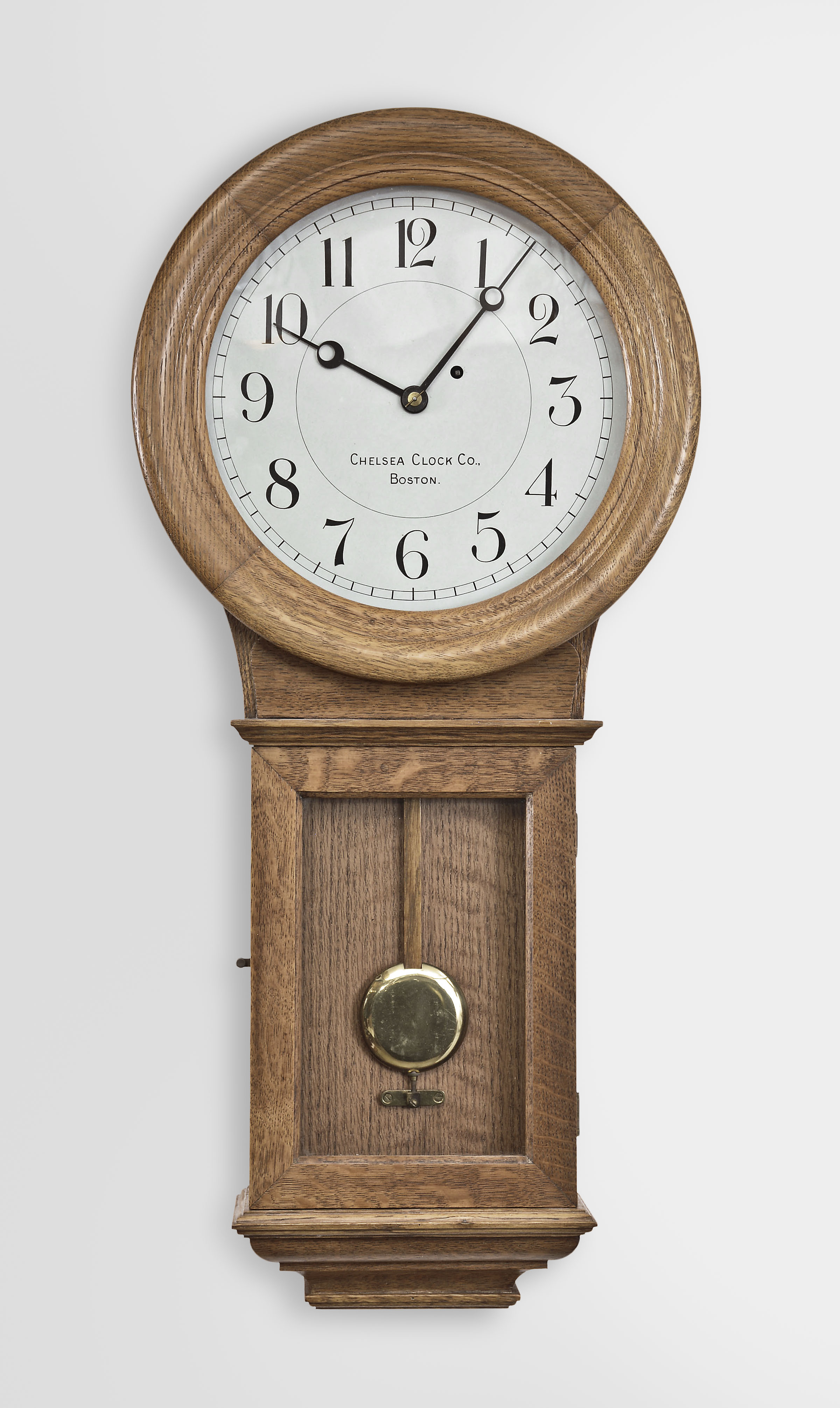Chelsea Clock Co., Boston, Mass., "Pendulum No. 1" hanging regulator, 8 day, time only, weight driven movement in an oak case with painted metal dial. — Antique Clocks Price Guide