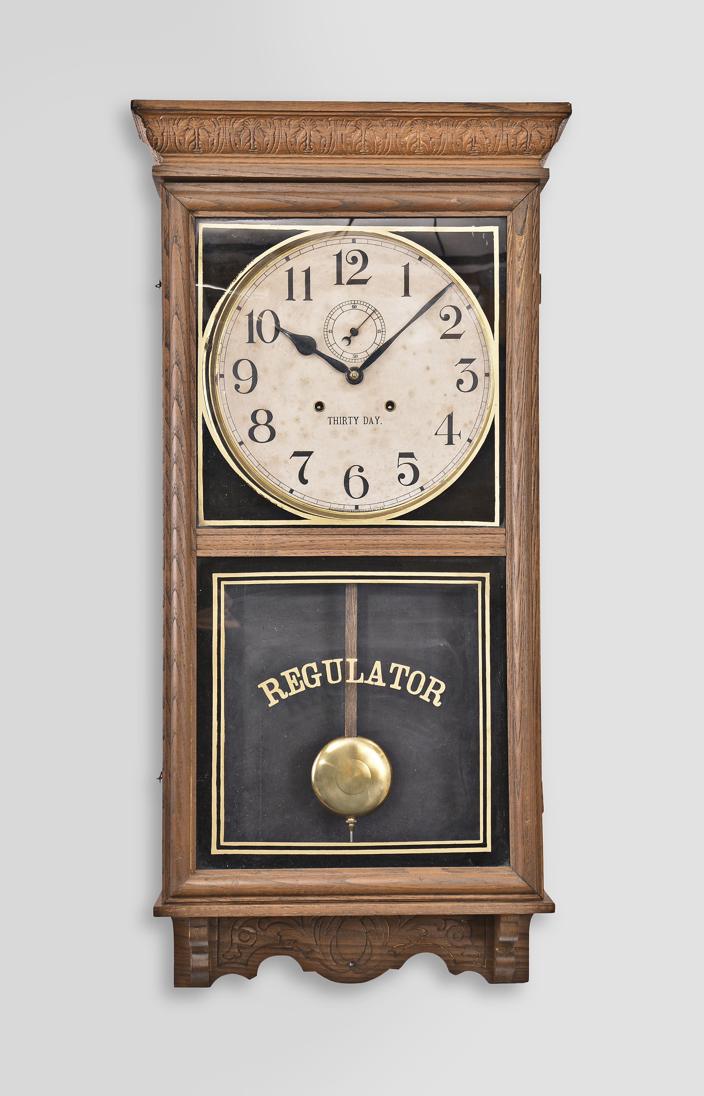 Waterbury Clock Co., Waterbury, Conn., "Stork" wall timepiece, 30 day, time only, twin spring movement in an oak case, 12 inch dial with subsidiary seconds, blued steel spade hands. — Antique Clocks Price Guide