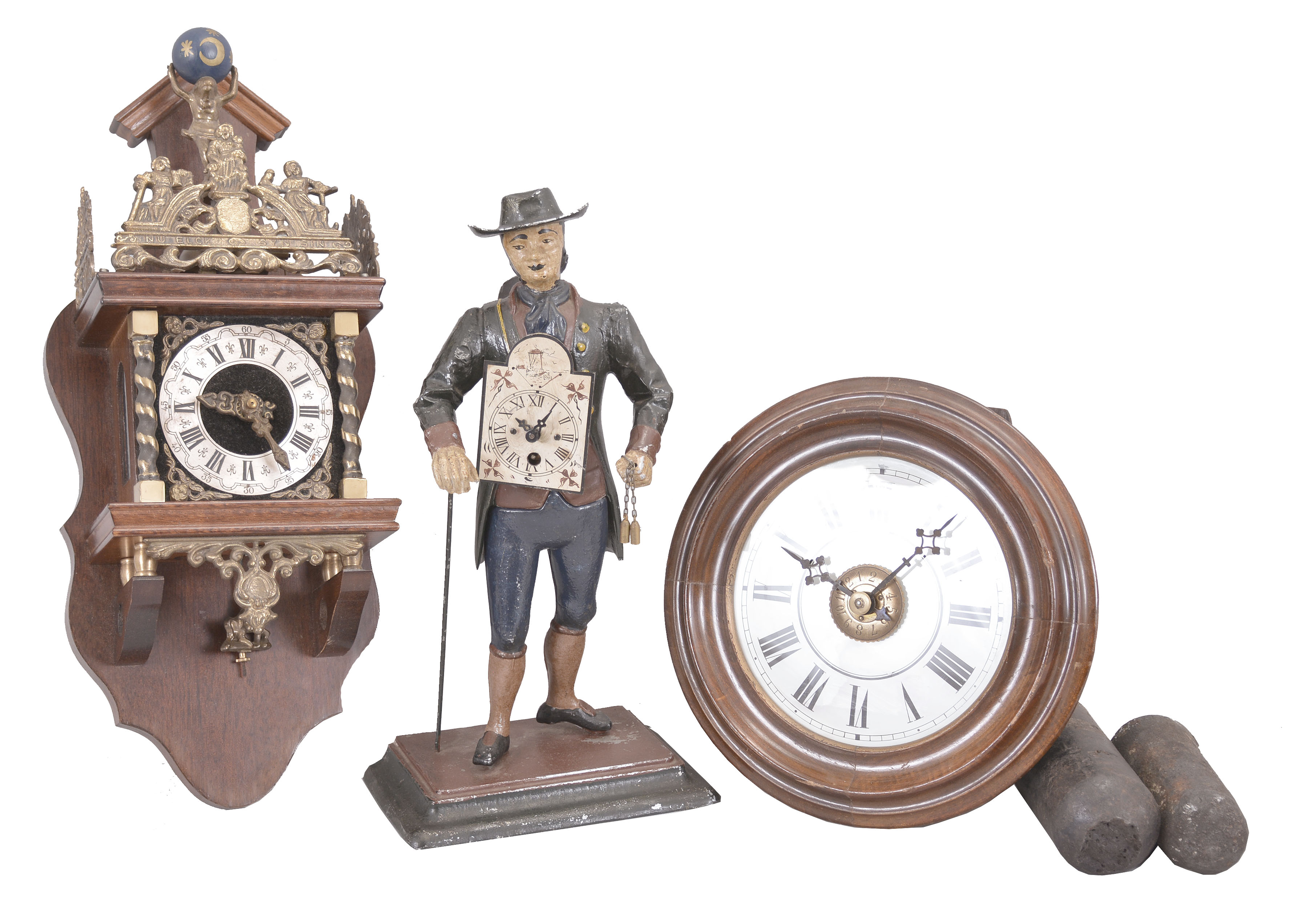 Clocks- 3 (Three): (1) Dutch reproduction wall clock, 8 day, time and strike, weight driven movement in a mahogany case with cast brass ornaments, silvered chapter ring, and topped by a figure supporting a sphere of the heavens, c1970; (2) Black Forest, Germany, two-weight wall or "postal" clock, 30 hour, time and alarm, weight driven wood-plate movement with a turned wood bezel and back-painted glass dial, c1880; (3) Peddler figure novelty clock, 30 hour, time only, spring driven movement in a painted cast metal figural case depicting a German clock peddler carrying two wag-on-the-wall clocks, c1990. — Antique Clocks Price Guide
