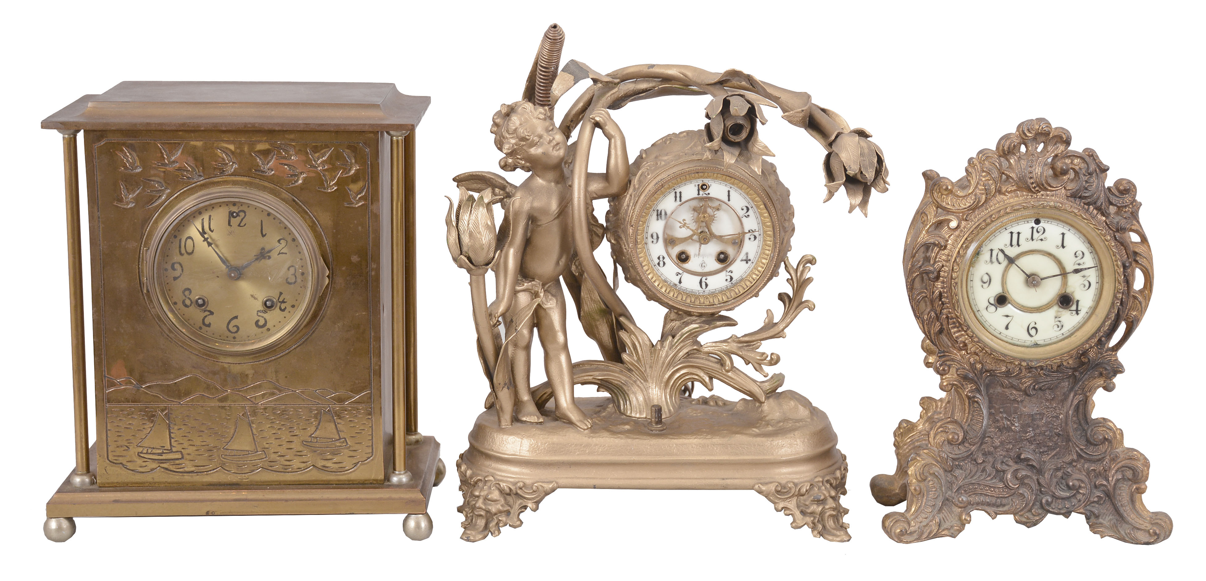 Clocks- 3 (Three): (1) Ansonia Clock Co., New York, NY, "Kensington" mantel clock, 8 day, time and strike, spring driven movement in a brass case with a brass dial, c1901; (2) Waterbury Clock Co., Waterbury, Conn., mantel clock, 8 day, time and strike, spring driven movement in a gilt brass case, c1910; (3) Wm. L. Gilbert Clock Co., Winsted, Conn., figural mantel clock, 8 day, time and strike, spring driven movement with Brocot escapement in a cast metal case with three incandescent bulbs, c1915. — Antique Clocks Price Guide