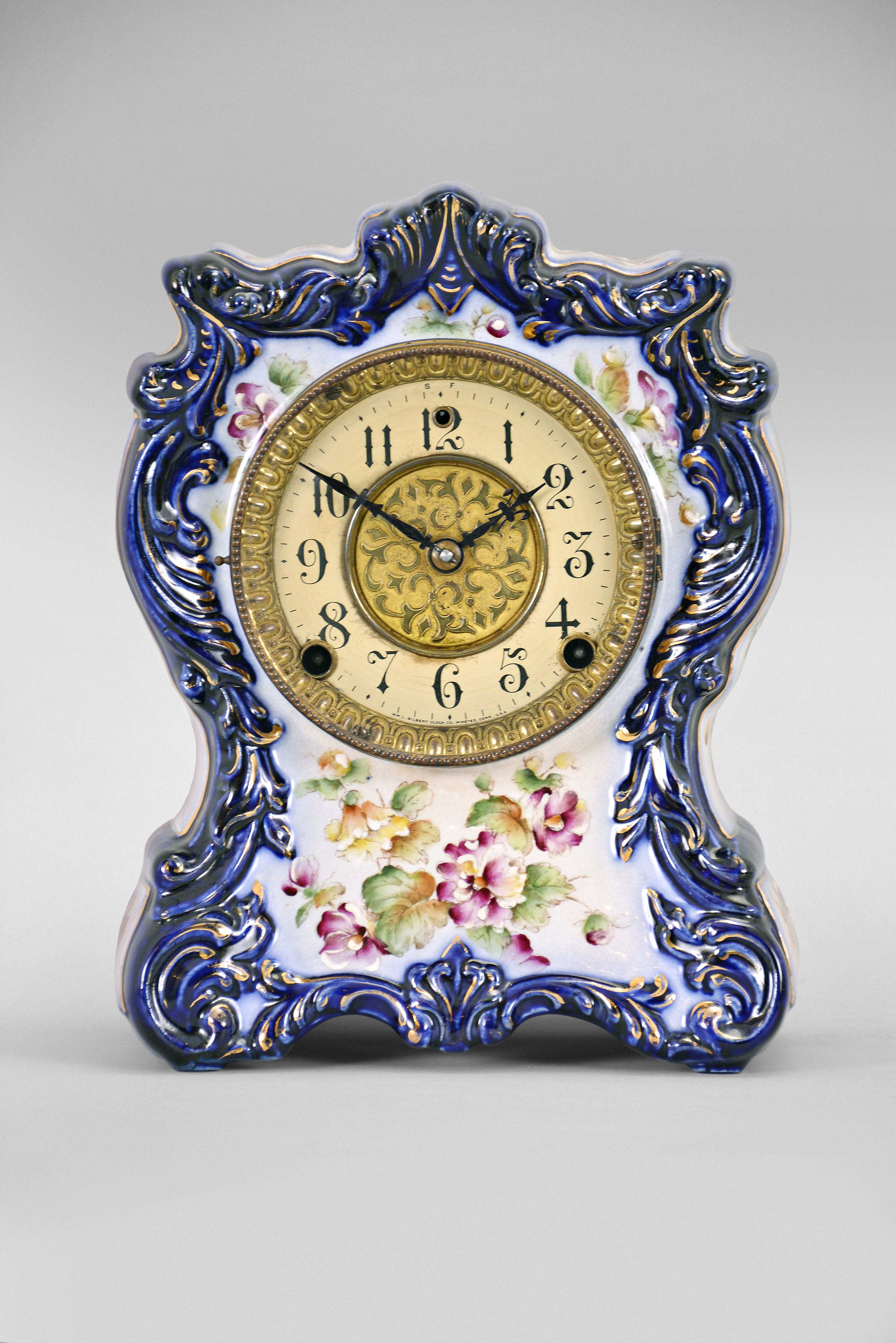 Clocks- 2 (Two) (1) William L. Gilbert Clock Co., Winsted, Conn., "No. 414", 8 day, time and strike spring brass movement porcelain mantel clock; (2) Ansonia Clock Co., New York, "Cabinet No. 51" mantel clock, 8 day, time and strike, spring driven movement in an oak case, brass dial with silvered chapter ring and cast spandrels, c1914. — Antique Clocks Price Guide