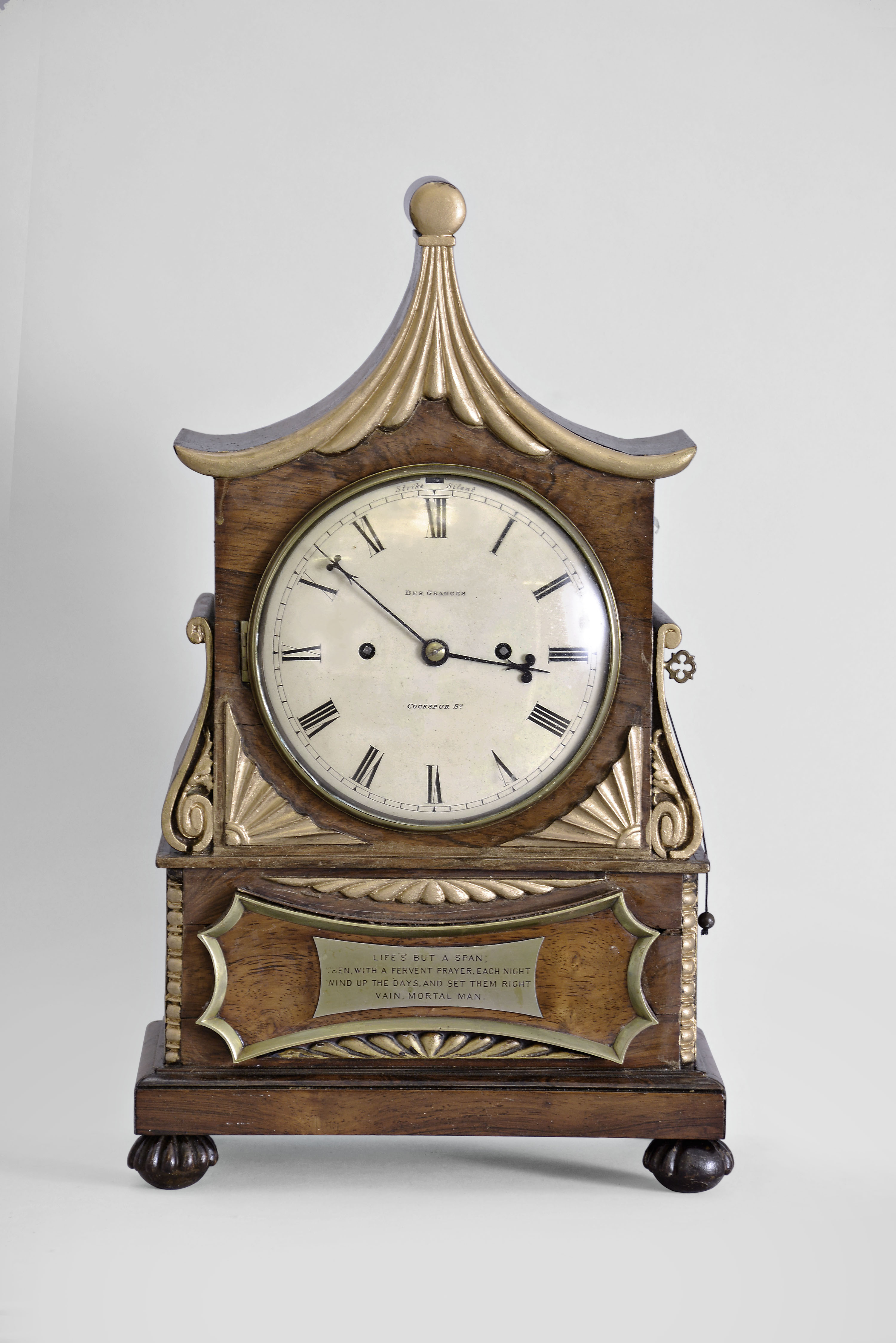 England, Des Granges, Cockspur St., mantel clock, 8 day, time and strike with pull repeat, spring driven fusee movement in a rosewood veneered case with Chinoiserie style on turned and carved feet, the case with applied and carved gilt ornaments and crest, signed dial, black steel fleur-de-lis hands, and plaque with poem considering the transient nature of life. — Antique Clocks Price Guide