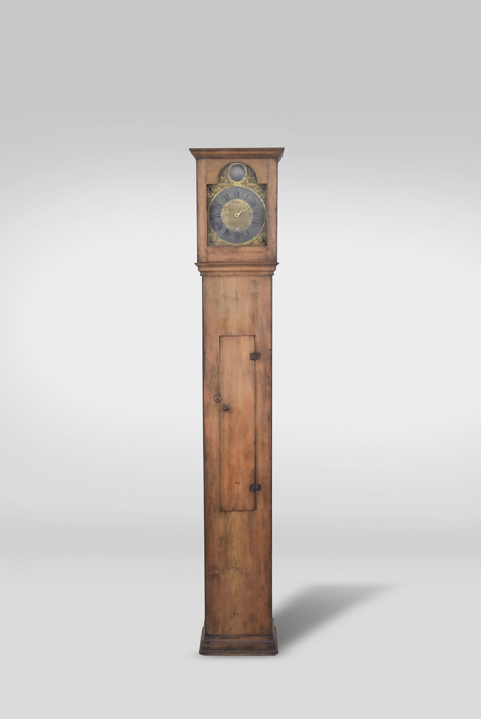 Nicholas Blaisdell, Amesbury, Mass., 30 hour, time and strike, weight driven brass movement in a rustic soft wood case. The brass dial has a pewter chapter ring, calendar aperture, cast brass spandrels and pewter boss with maker's name engraved. — Antique Clocks Price Guide