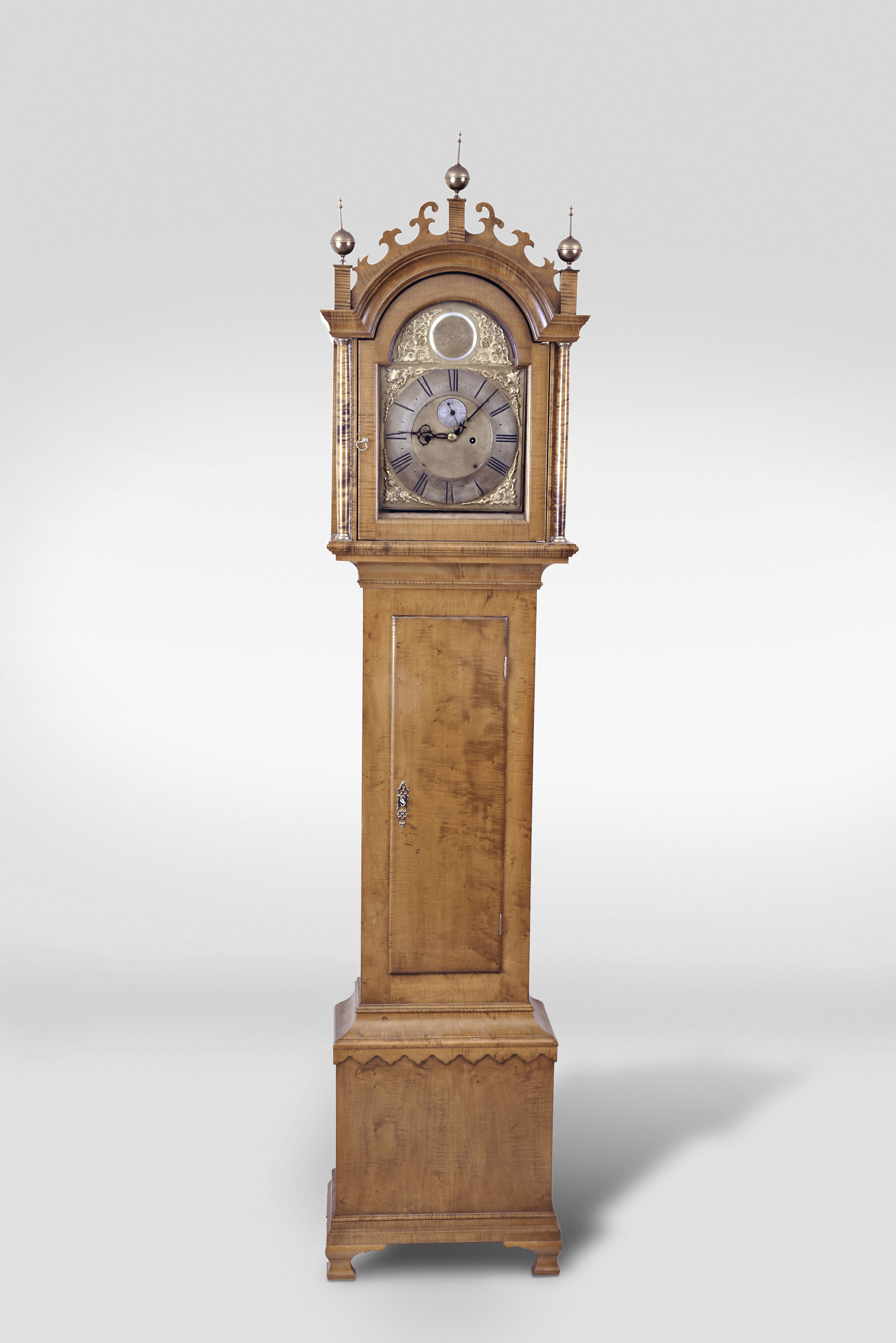 Tall clock, 8 day, time and strike, weight driven English movement in a tiger maple Norwich-style "whale's tails" fretwork and scalloped skirt case ogee foot modern case by Robert Materne of Bristol, RI. Period movement fitted with a modern brass dial affixed to wood with a name boss inscribed Paul Rogers, Berwick (Maine) . — Antique Clocks Price Guide