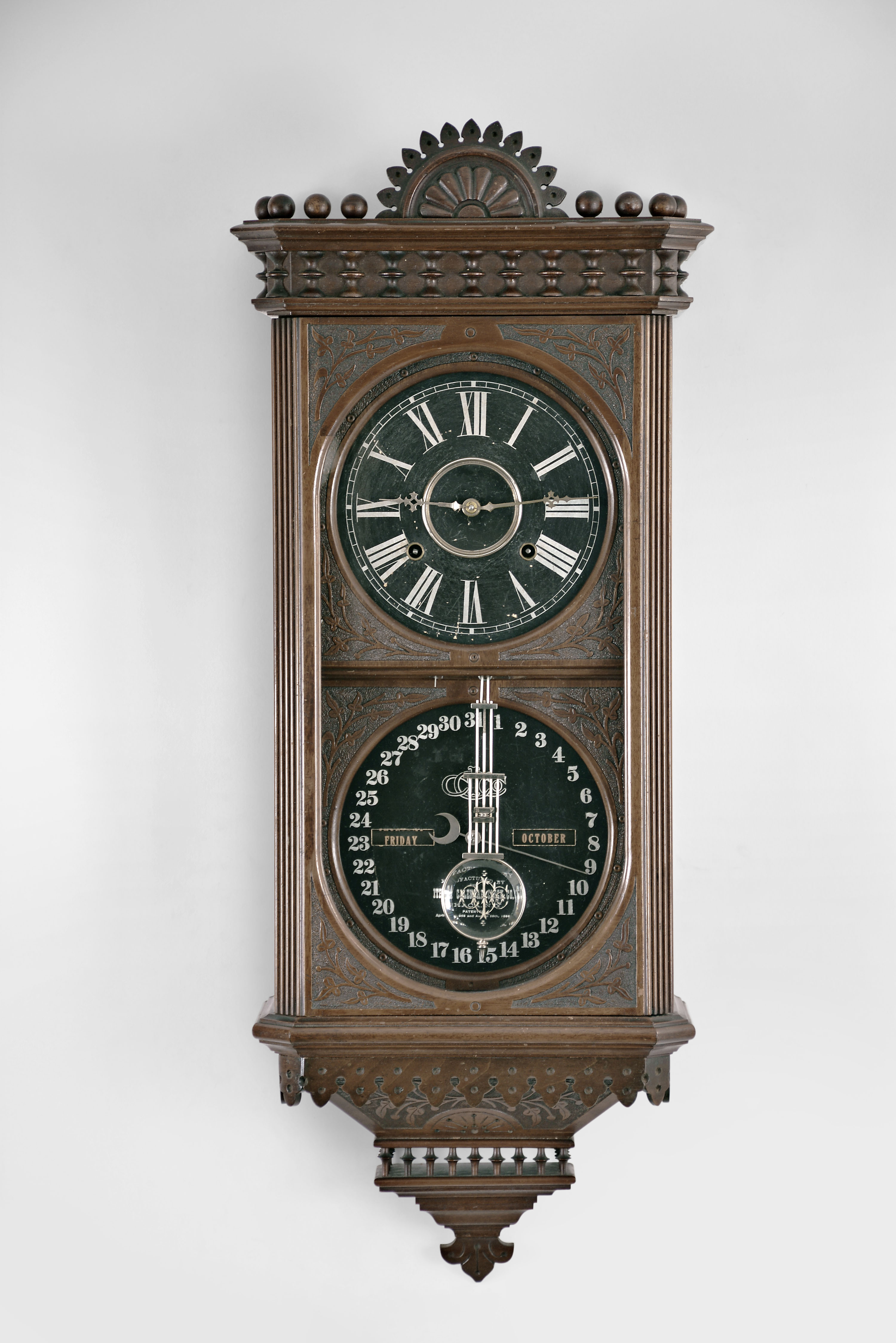 Ithaca Calendar Clock Co., Ithaca, NY, "Hanging Kildare" calendar clock with a spring driven 8 day time and strike E. N. Welch movement and a H. B. Horton patented perpetual calendar mechanism in a mahogany case. — Antique Clocks Price Guide