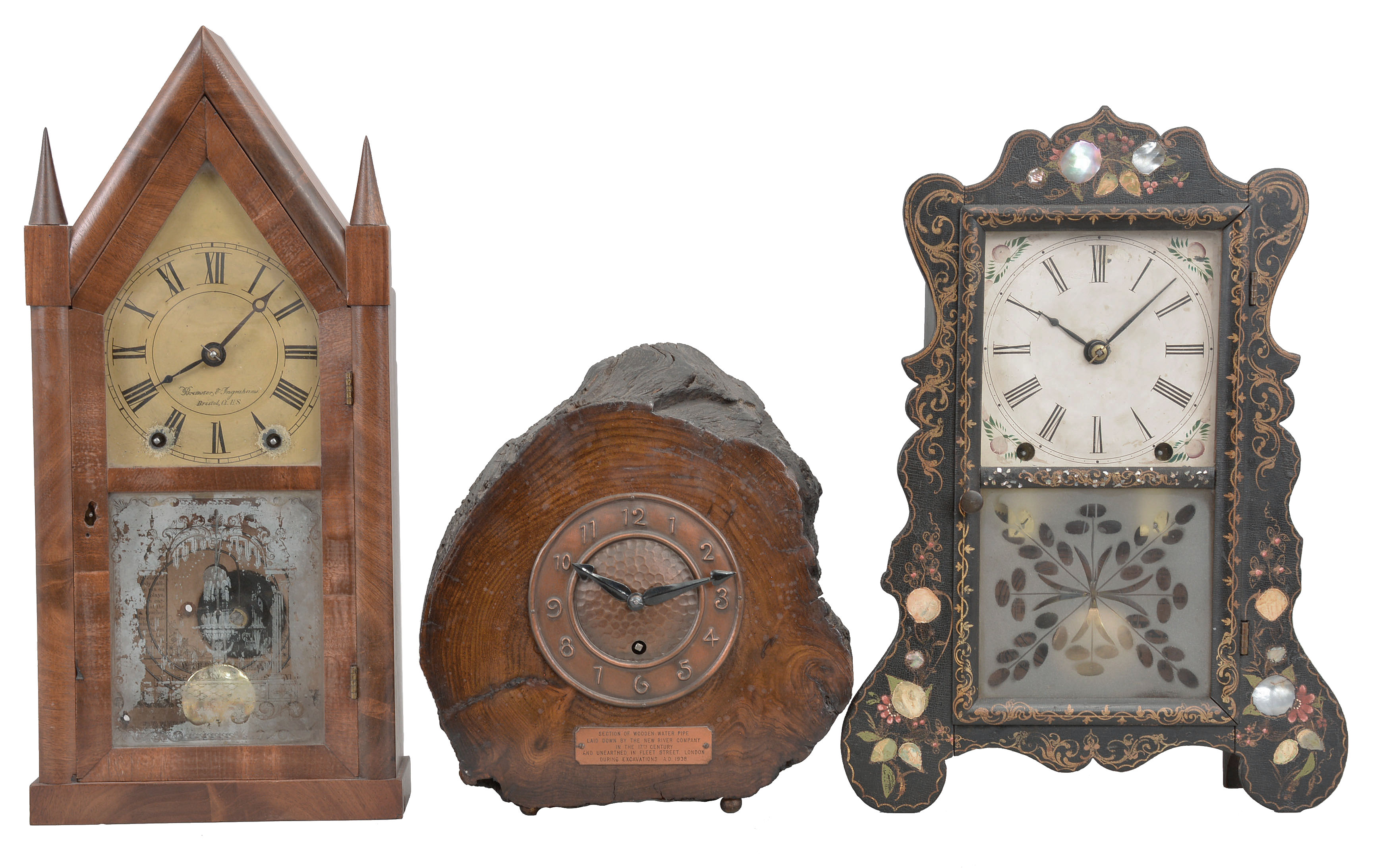 Clocks- 5 (Five): (1) Brewster Manufacturing Co., Bristol, Conn., mantel clock, 8 day, time and strike, spring driven movement in a black wood case with mother of pearl and painted decorations, c1852; (2) Brewster &amp; Ingrahams, Bristol, Conn., sharp gothic or steeple clock, 8 day, time and strike, spring driven movement in a walnut veneer case, c1850; (3) England, mantel clock, 8 day, time only, spring driven movement with balance wheel, in wood case that was once a section of water pipe in 17th century London, c1908. (4) Ansonia Brass &amp; Copper Co., Ansonia, Conn., "Gilt Column", 8 day, time and strike, spring driven movement in a walnut veneer case, c1874; (5) Elisha Manross, Bristol, Conn., miniature ogee shelf clock, 30 hour, time and strike, spring driven movement in a walnut veneer case and William B. Fenn eagle glass, c1850. — Antique Clocks Price Guide