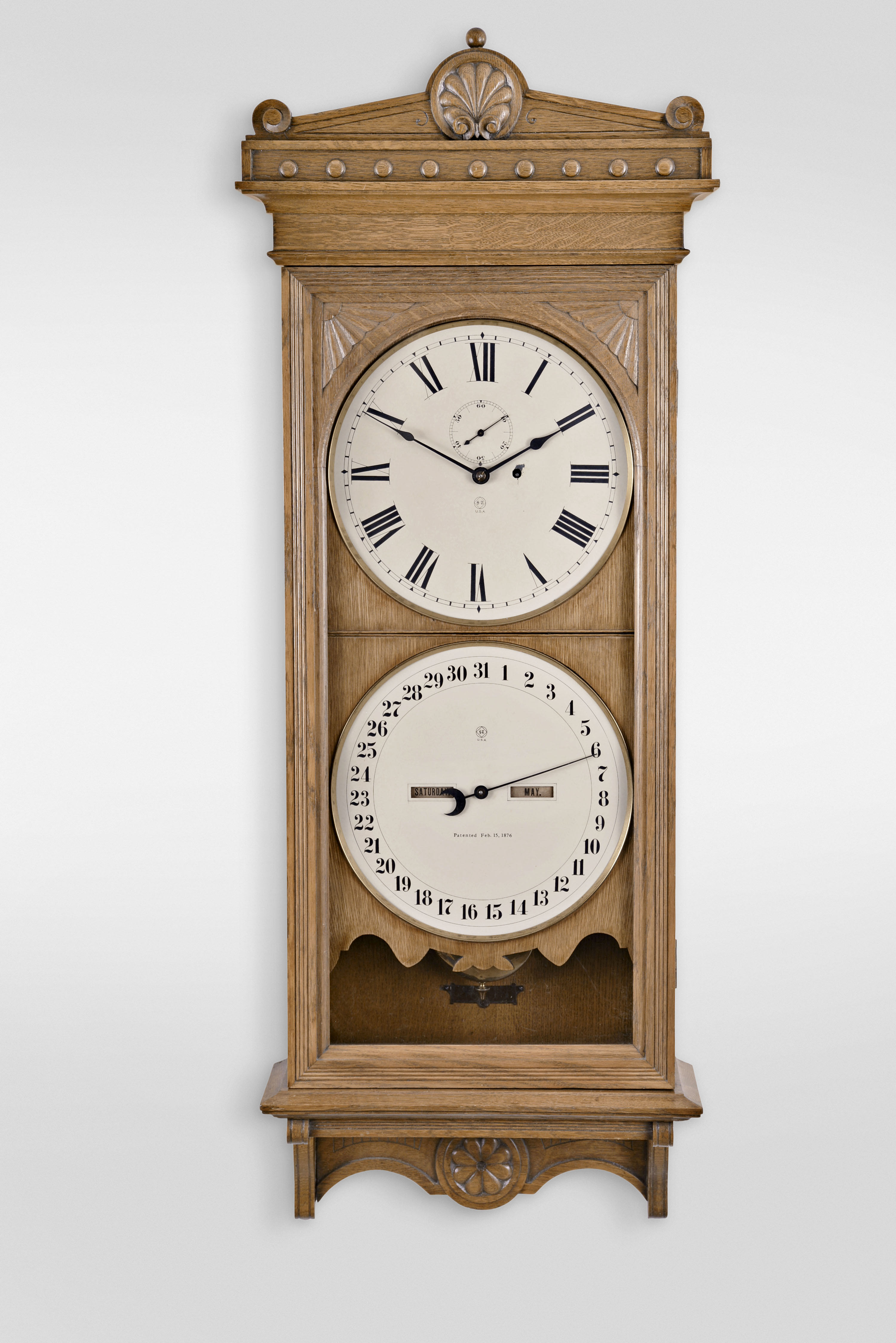Seth Thomas Clock Co., Thomaston, Conn., "Office Calendar No. 13" wall hanging clock with a weight driven 8 day timepiece movement, maintaining power and an R. T. Andrews patented perpetual calendar mechanism in an oak case. — Antique Clocks Price Guide