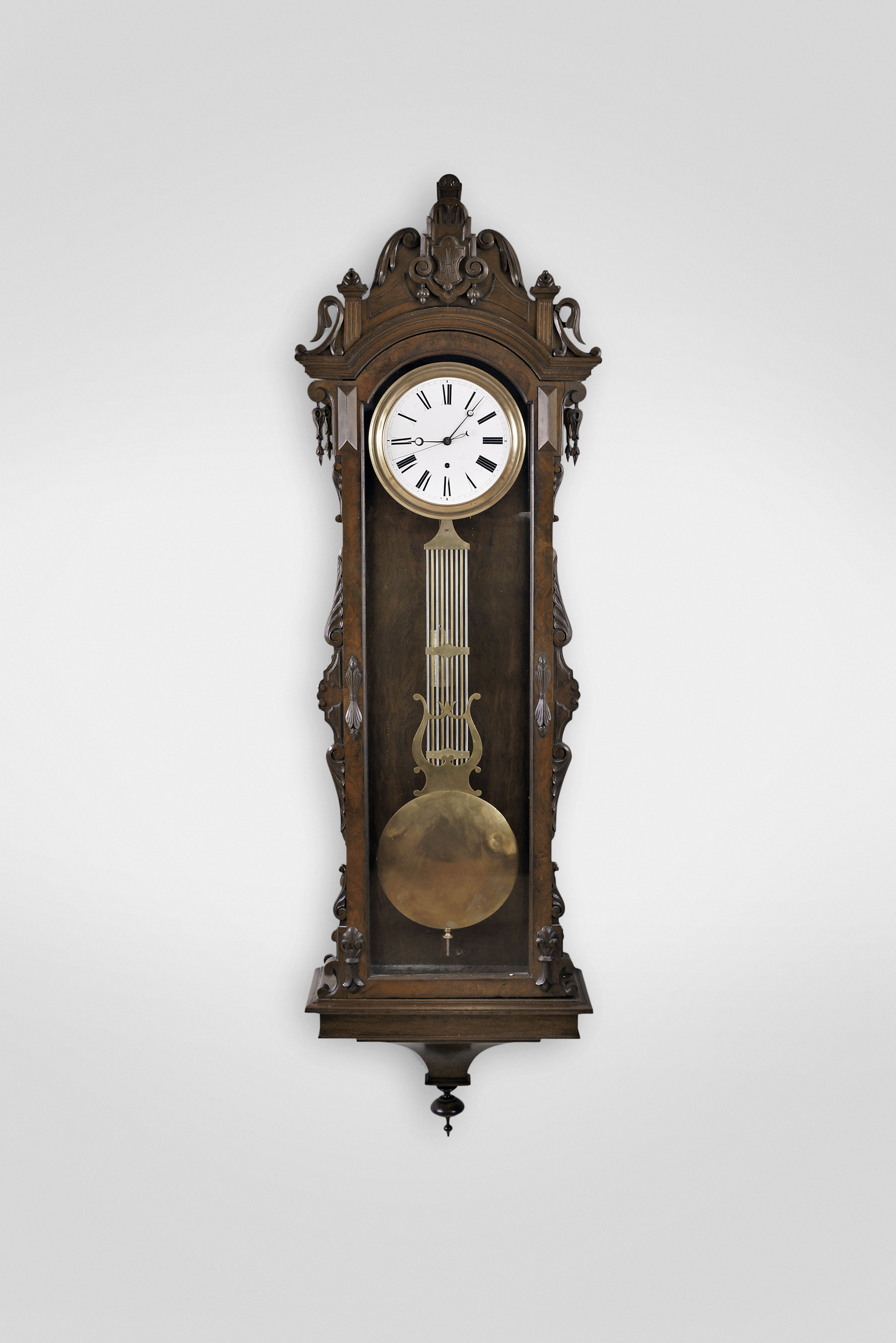 Ansonia Clock Co., New York, New York, "Regulator No. 14" hanging jeweler's regulator, 8 day, time only, weight driven Swiss movement with gridiron lyre pendulum and pinwheel escapement in a carved walnut and burl walnut case with white enamel dial and center sweep seconds — Antique Clocks Price Guide