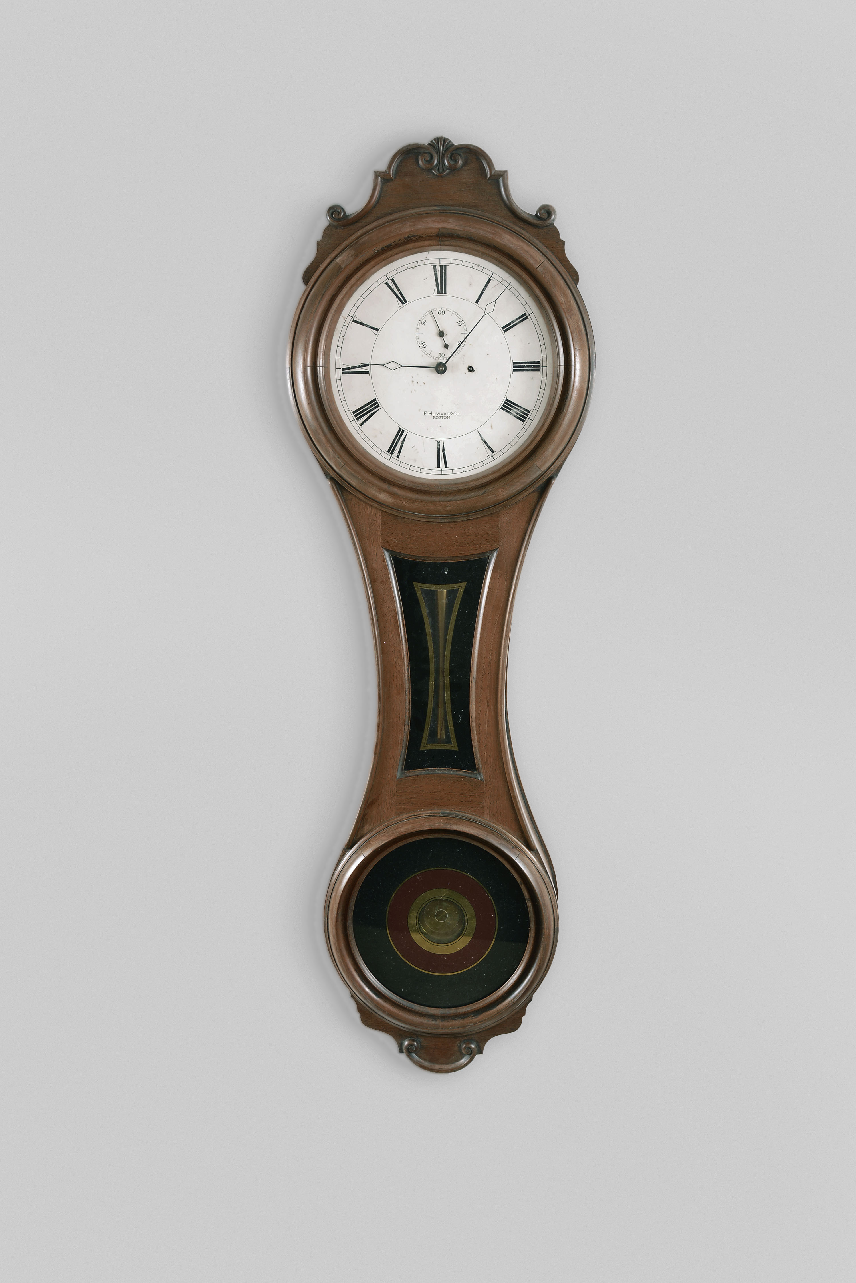 E. Howard &amp; Co., Boston, Mass., "No. 6 Regulator", the largest figure eight wall clock, 8 day, time only, weight driven movement in a black walnut case with a painted metal dial, reverse painted tablets and damascened pendulum bob — Antique Clocks Price Guide