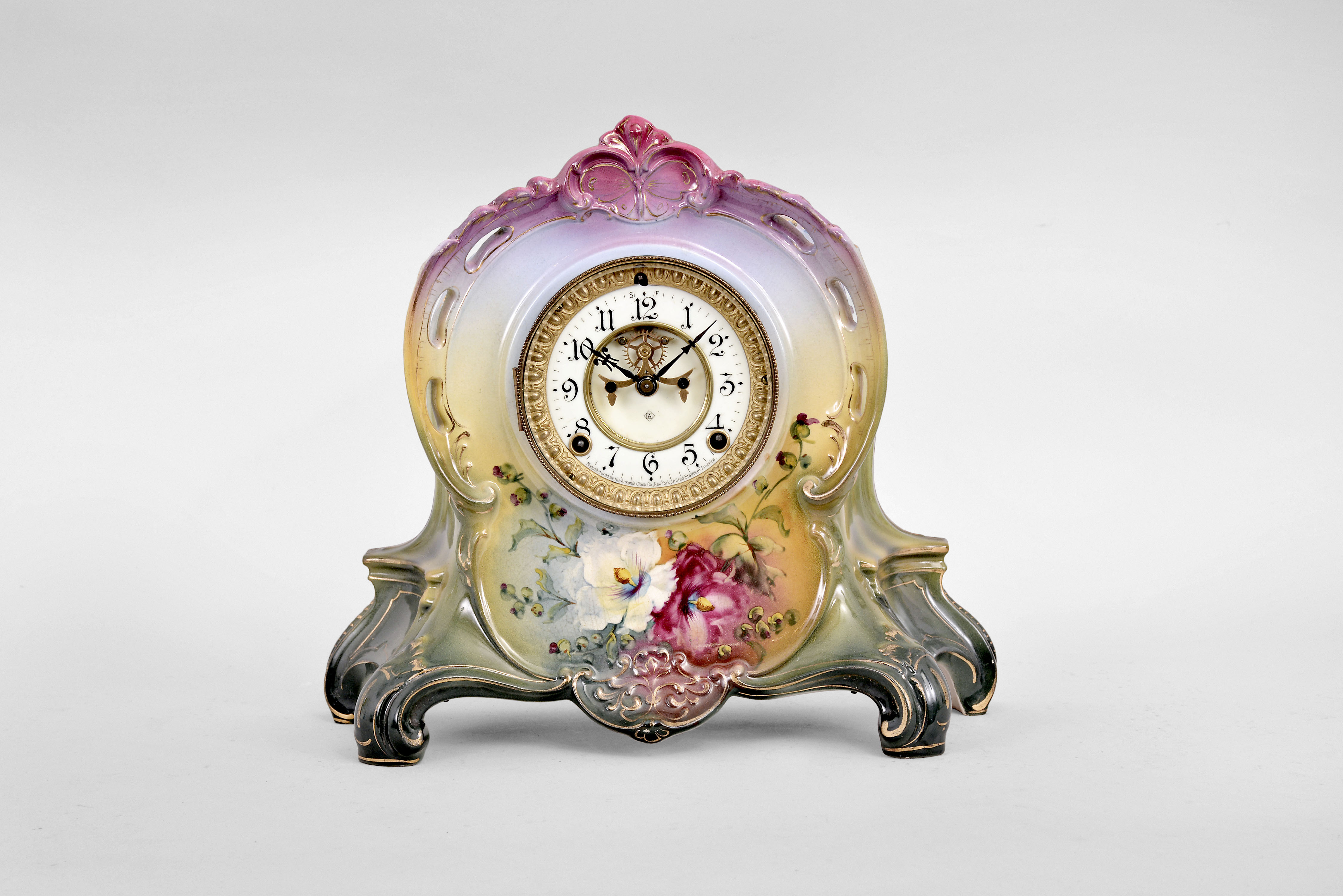 Ansonia Clock Co., New York, "La Riviere" mantel clock, 8 day, time and strike, spring driven movement with visible Brocot escapement in a polychrome porcelain Royal Bonn case with vibrant floral design. — Antique Clocks Price Guide