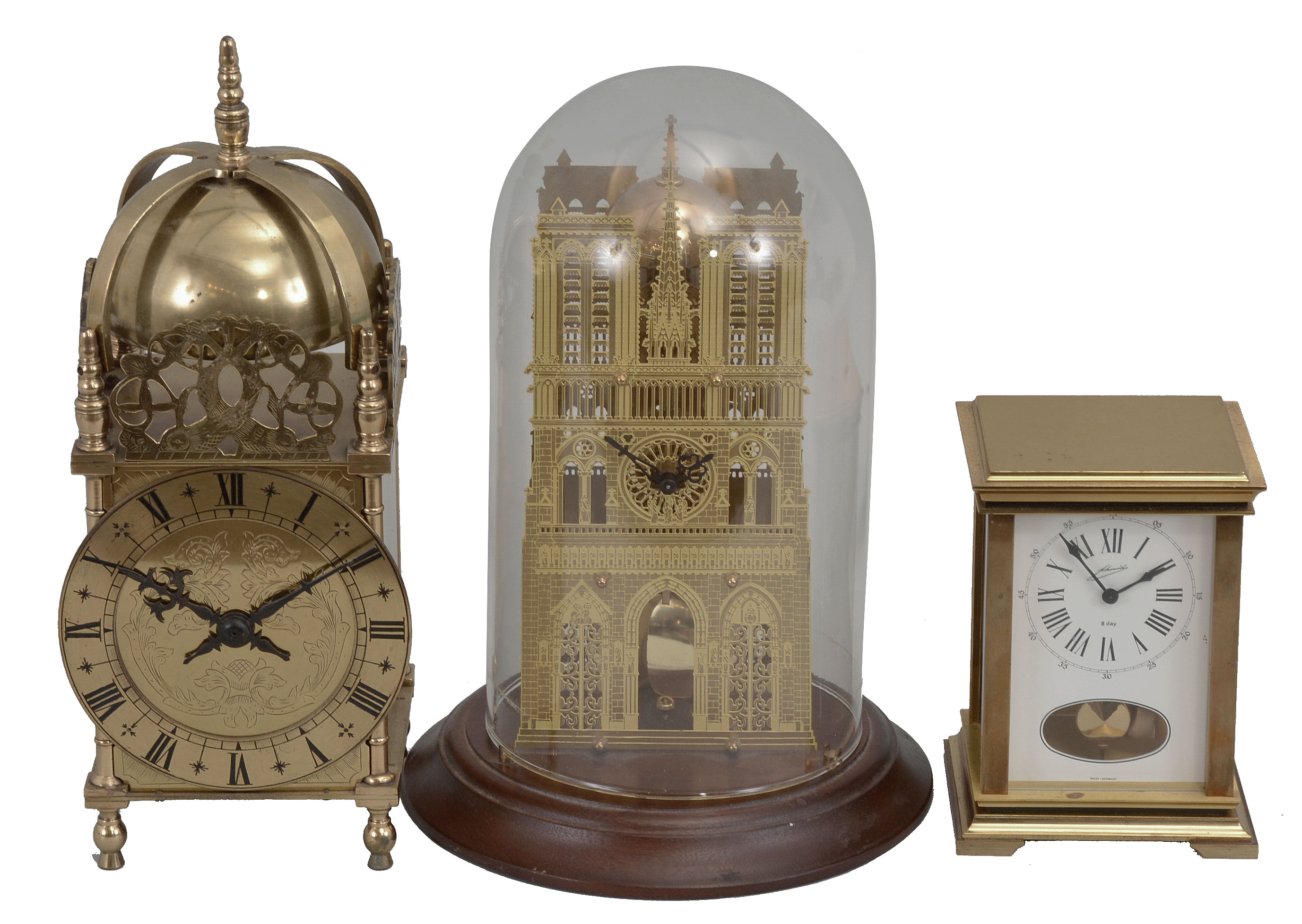 Clocks- 3 (Three): (1) All British Escapement Co., London, lantern clock reproduction, 8 day, time only, spring driven balance wheel movement with lever escapement in a brass case, c1940; (2) Hermle, Gosheim, Germany, skeleton style clock, 8 day, time and passing strike, spring driven movement in a pierced brass case under a glass dome, c1989 (3) W.&amp; A. Schmid,Schwenningen, Germany, carriage style clock, 8 day, time and strike, spring driven pendulum movement in a brass and glass case, c1985. — Antique Clocks Price Guide