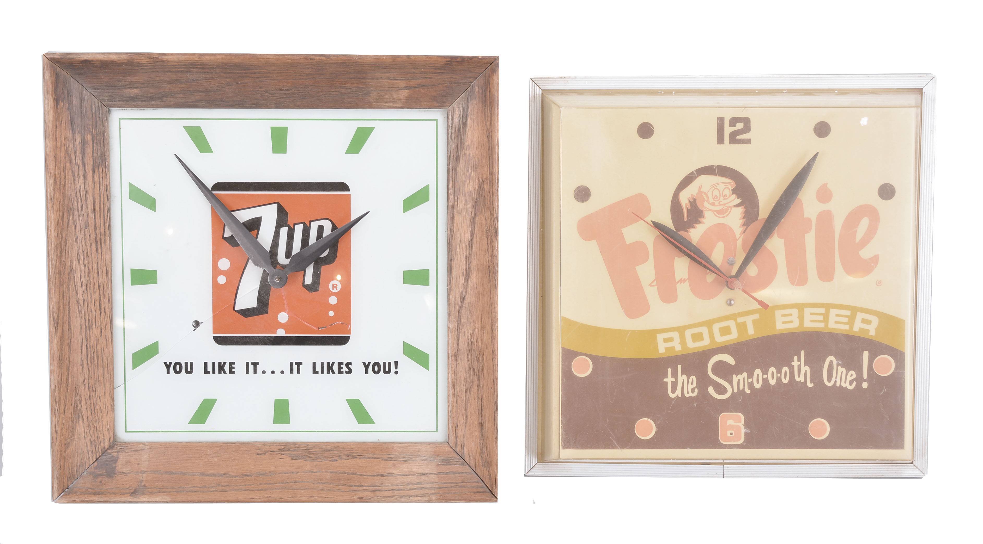 Clocks- 4 (Four) Plug-in Electric Advertising: (1) 7-Up wall clock with back-painted glass dial and wood frame, internal light with logo and the words "You Like It...It Likes You! "; (2) Genesee Beer &amp; Ale wall clock with sweep seconds and internal illumination; (3) Frostie Root Beer clock with sweep seconds, dial with Frostie logo and tagline reading "The Smooth One! "; (4) Hires Draft Style Root Beer clock with internal illumination. — Antique Clocks Price Guide
