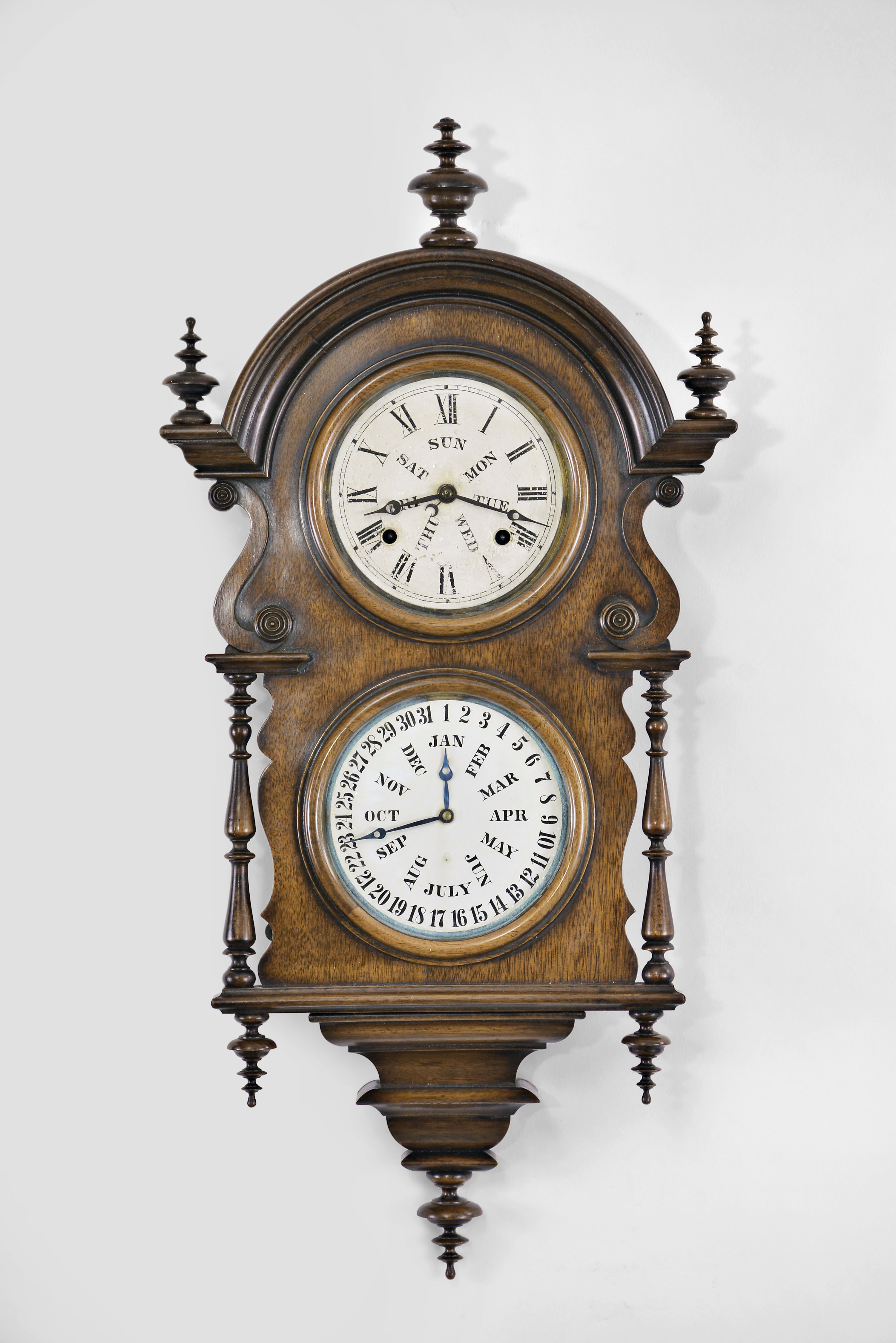 Welch, Spring, &amp; Co., Forestville, Conn., "Wagner" hanging calendar clock with a spring driven 8 day time and strike movement and a B. B. Lewis patented perpetual calendar mechanism in a walnut case. — Antique Clocks Price Guide