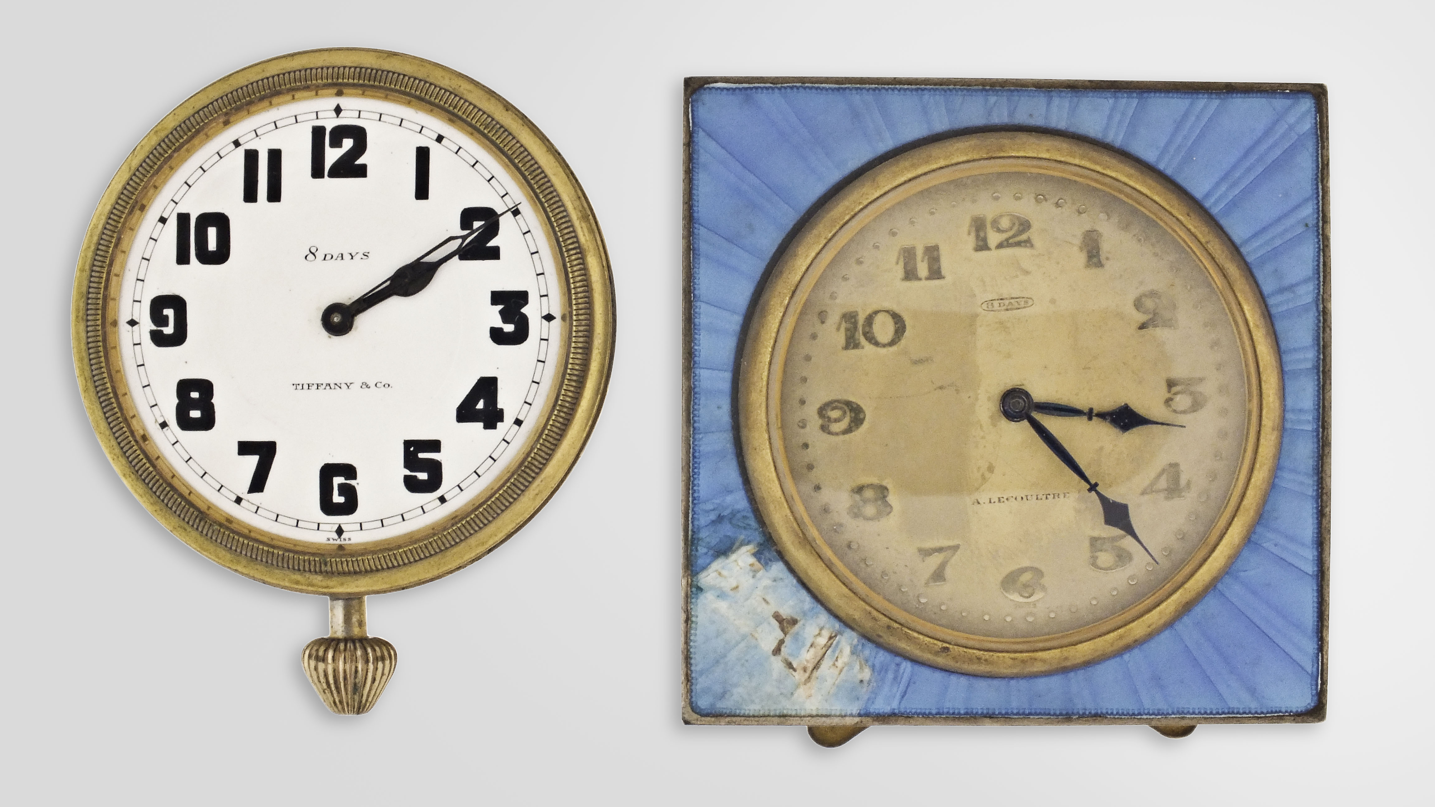 Desk or nightstand clocks- 2 (Two): the first signed A. LeCoultre, 8 day, 7 jewel nickel movement, Arabic numeral metal dial, square blue guilloche enamel case with easel back, 2 5/8 in sq., the other an Octavia Watch Co. for Tiffany &amp; Co., 8 day, 15 jewel nickel movement, Arabic numeral white enamel dial, gilt open face case, lacking stand, 2 1/4in — Antique Clocks Price Guide
