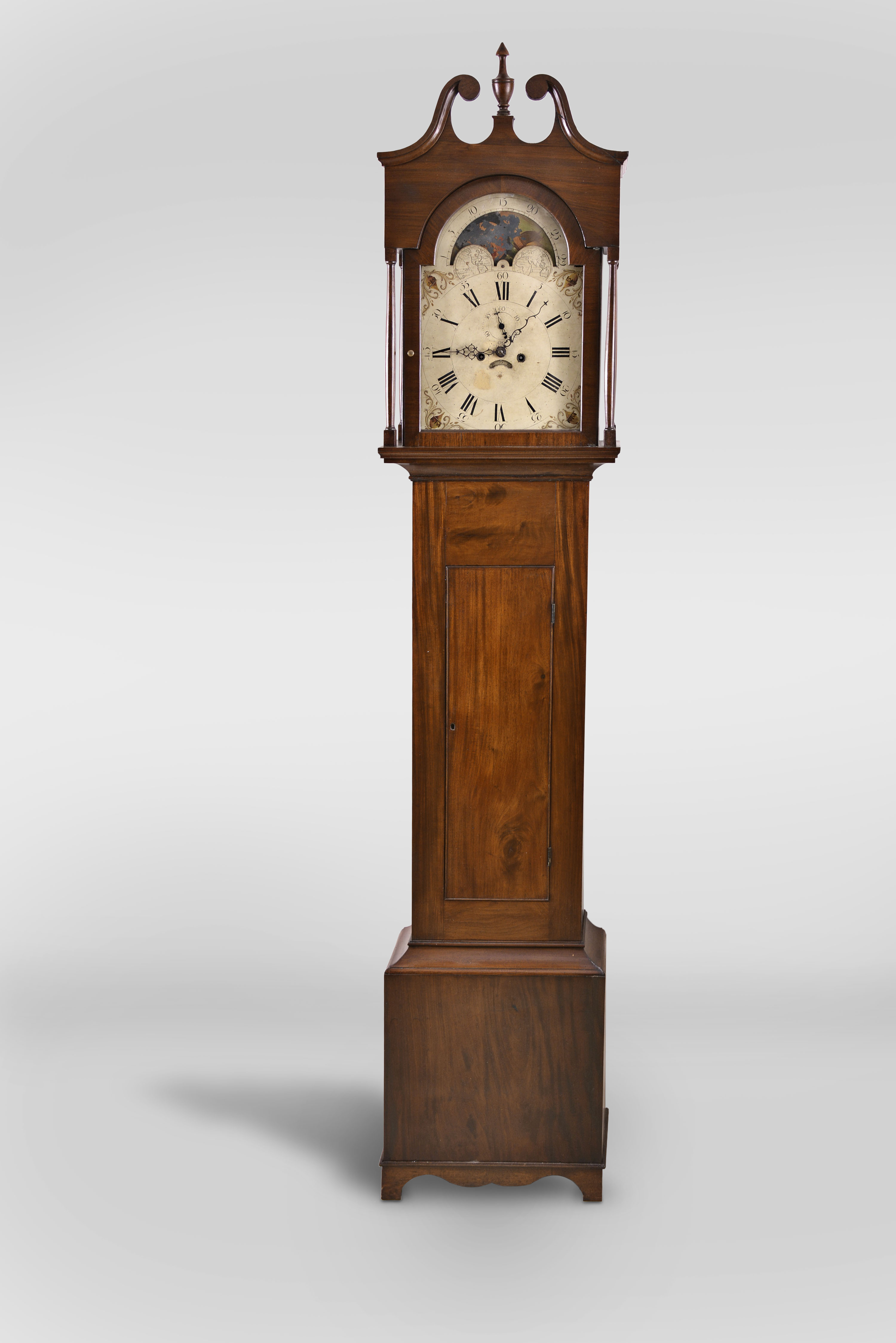 New Jersey area tall case clock, 8 day, time and strike, weight driven movement in a mahogany and mahogany veneer case with a broken arch pediment, center finial, four full columns flanking hood over rectangular trunk door and base with crotch mahogany veneer. The painted metal dial has moon phase, seconds bit and calendar. — Antique Clocks Price Guide