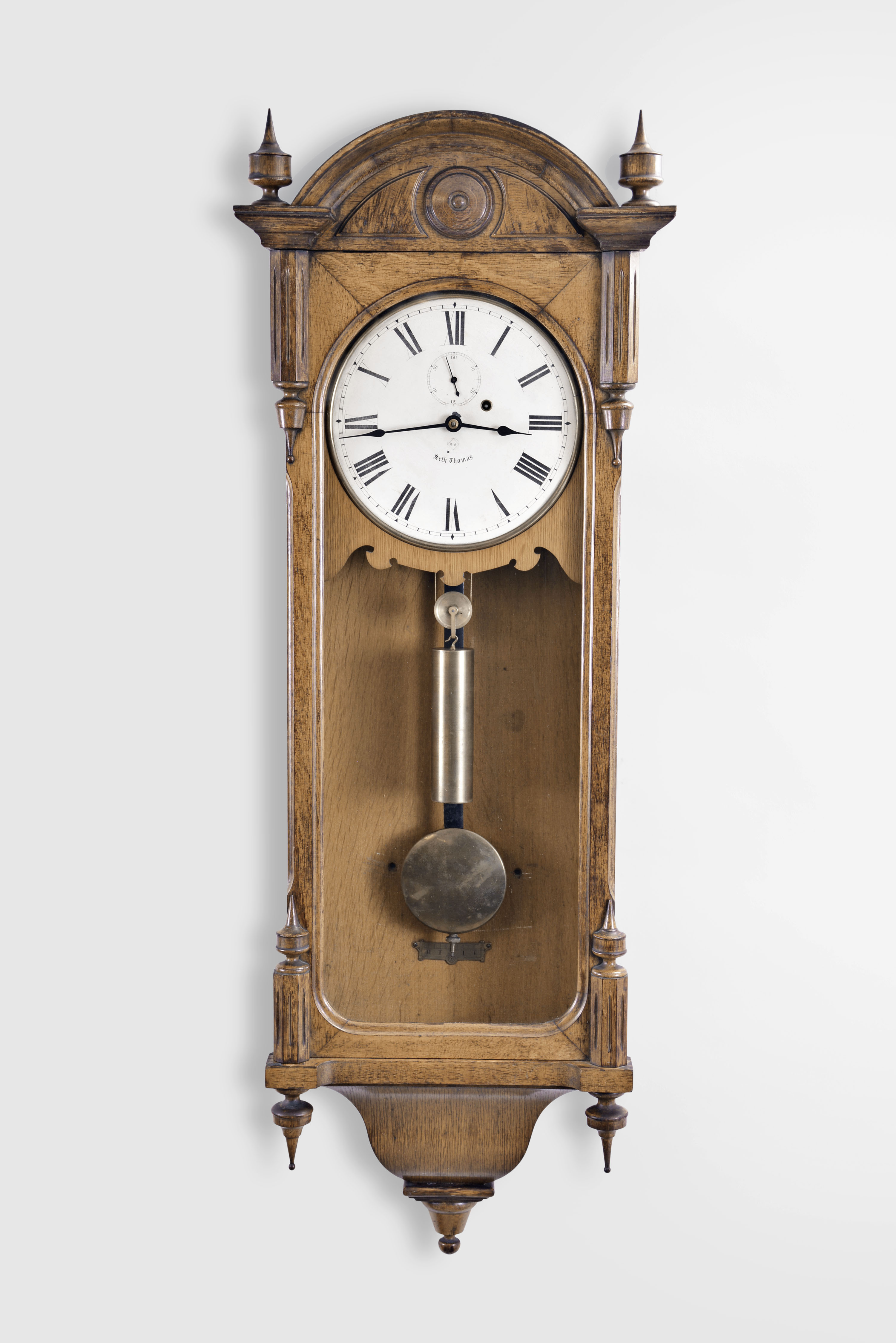 Seth Thomas Clock Co., Thomaston, Conn., "Regulator No. 6" hanging clock with a weight driven 8 day timepiece movement with a deadbeat escapement and maintaining power in an oak case. — Antique Clocks Price Guide