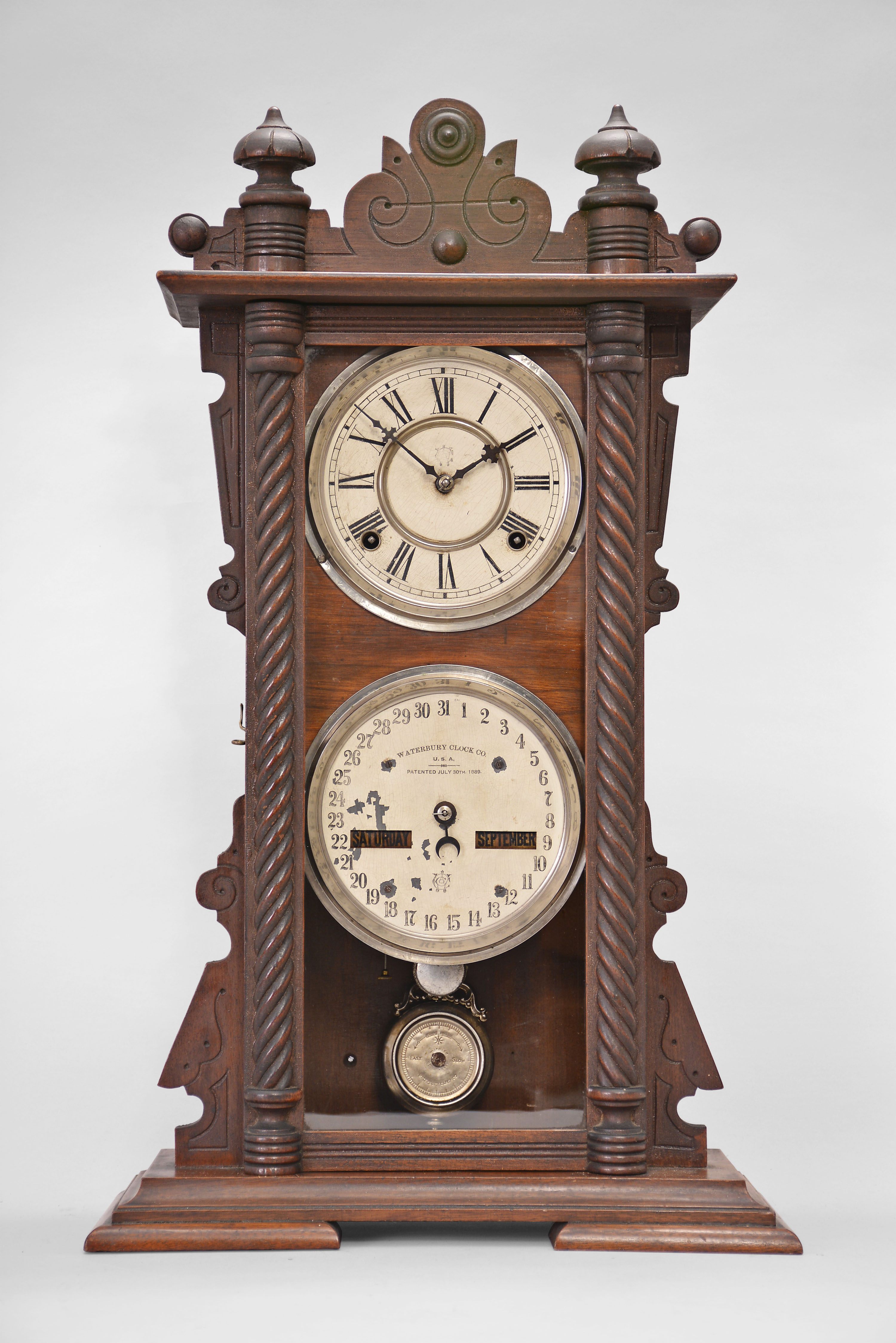 Waterbury Clock Co., Waterbury, Conn., "Calendar No. 40" shelf clock with a spring driven 8 day time and half hour strike movement in a walnut case. — Antique Clocks Price Guide