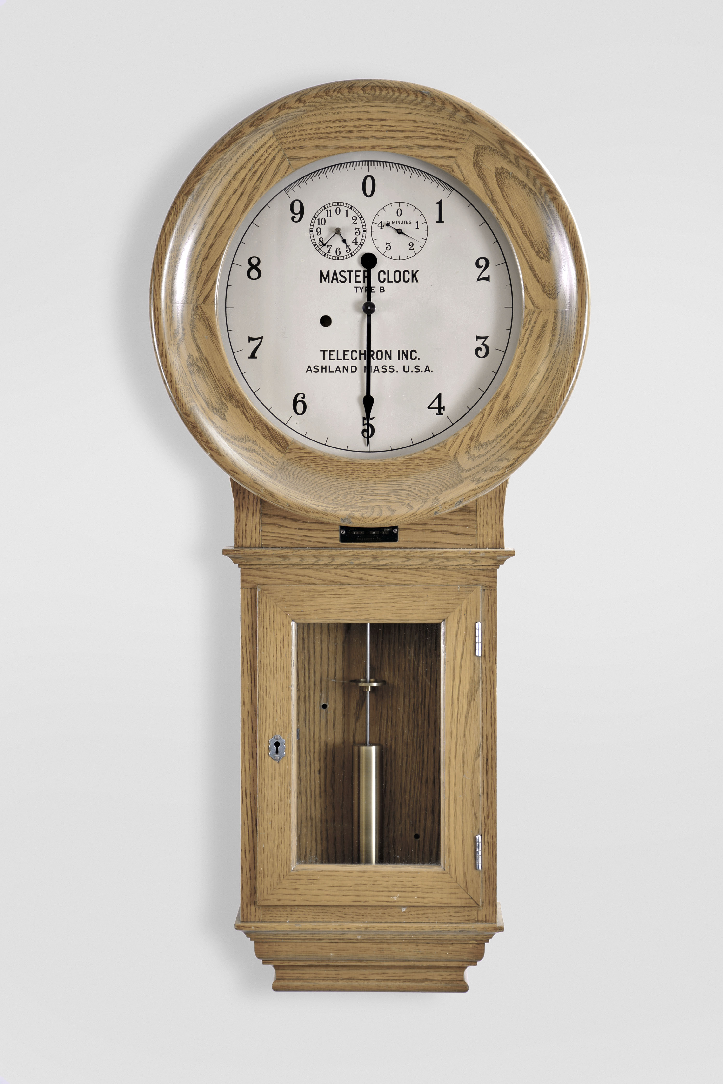 Warren Telechron Co., Ashland, Mass., "Warren B. Master Clock", (No. 127 Frequency Clock) in an oak case with silvered dial, 110v motor combined with quality spring movement. Spring movement moves the center hand backwards; electric movement moves it forward, serial #1036 — Antique Clocks Price Guide