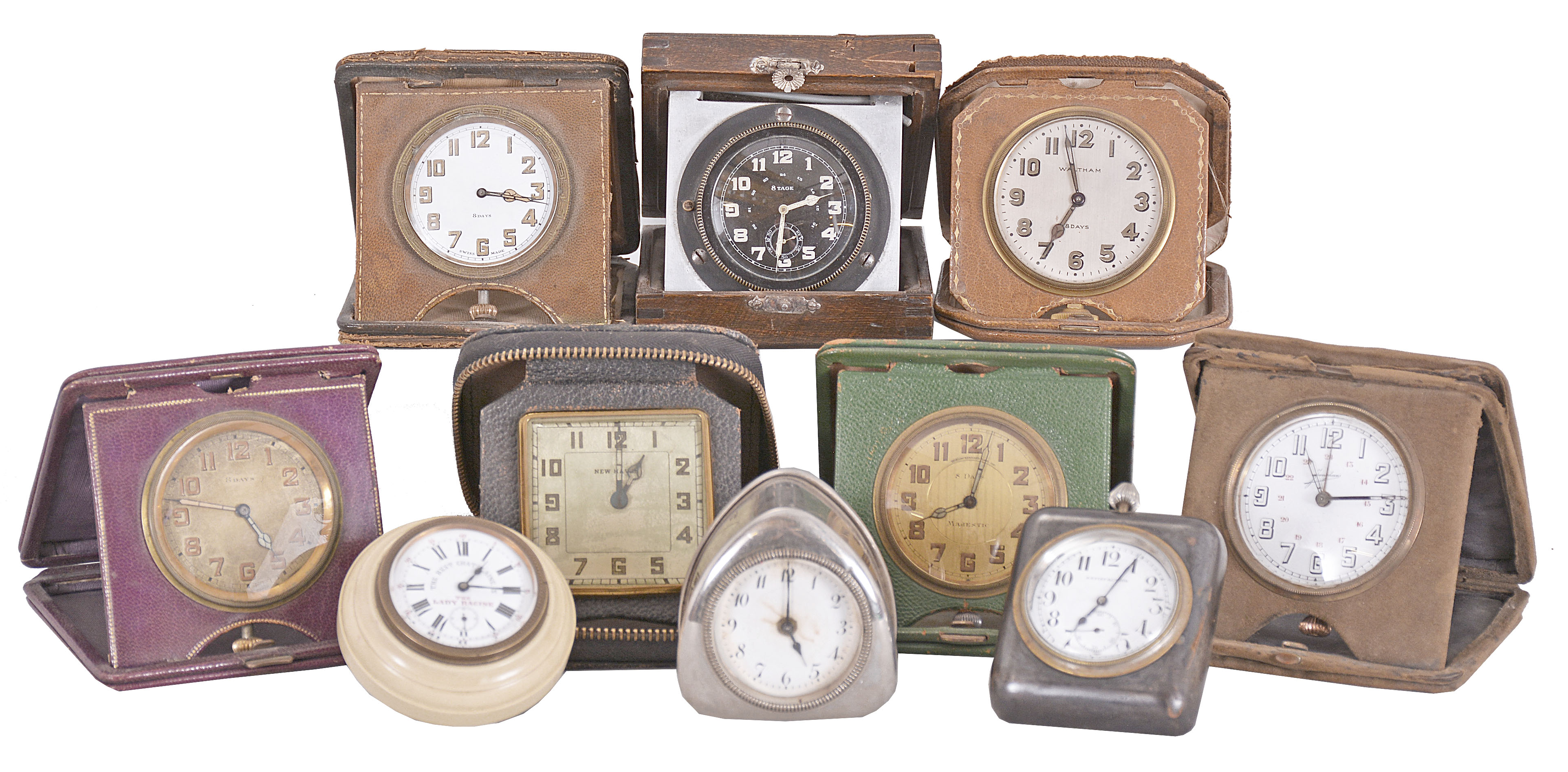 Desk and travel clocks- 10 (Ten), 30 hour and 8 day, Swiss and American, makers including Waltham, New Haven, Majestic, Junghans, and others, most with folding, leather bound cases, one desk clock with molded celluloid case and white enamel dial advertising the Lady Racine watch, another with gunmetal case and easel back, and more — Antique Clocks Price Guide