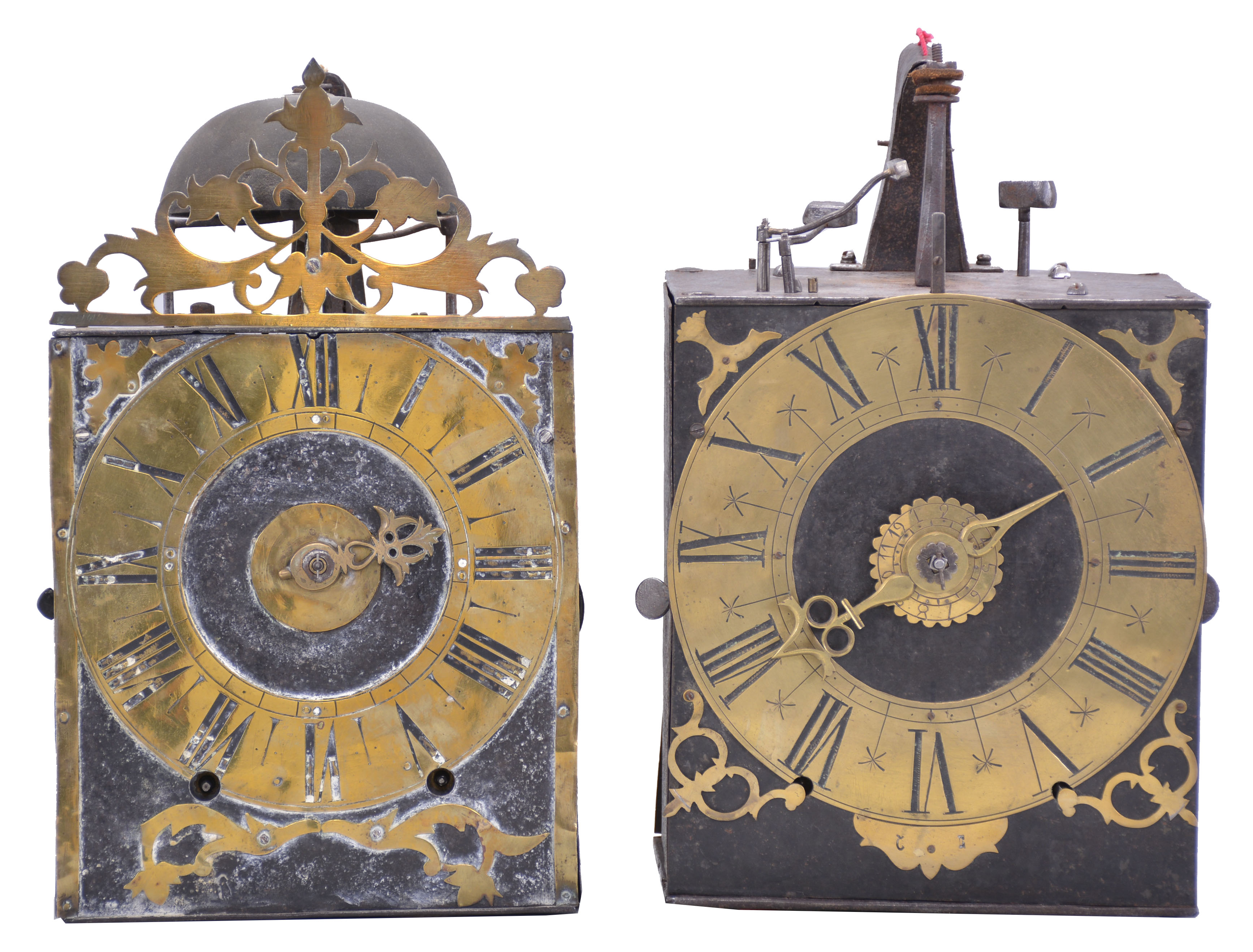 Clocks- 2 (Two) Early Comtoise: (1) France, Comtoise clock, 8 day, time and strike, weight driven movement with verge escapement, thread suspension with rear-hanging pendulum in a iron post and plate frame, brass chapter ring with engraved Roman numerals, applied spandrels and pivoted winding arbor shutters, single brass hand, topped by flat pierced brass fronton, first half of the 18th Century. (2) France, Comtoise clock, 8 day, time and strike with alarm, weight driven movement with verge escapement, thread suspension with rear-hanging pendulum in a iron post and plate frame, brass chapter ring with engraved Roman numerals, applied spandrels and pivoted winding arbor shutters, single brass hand, first half of the 18th Century. — Antique Clocks Price Guide