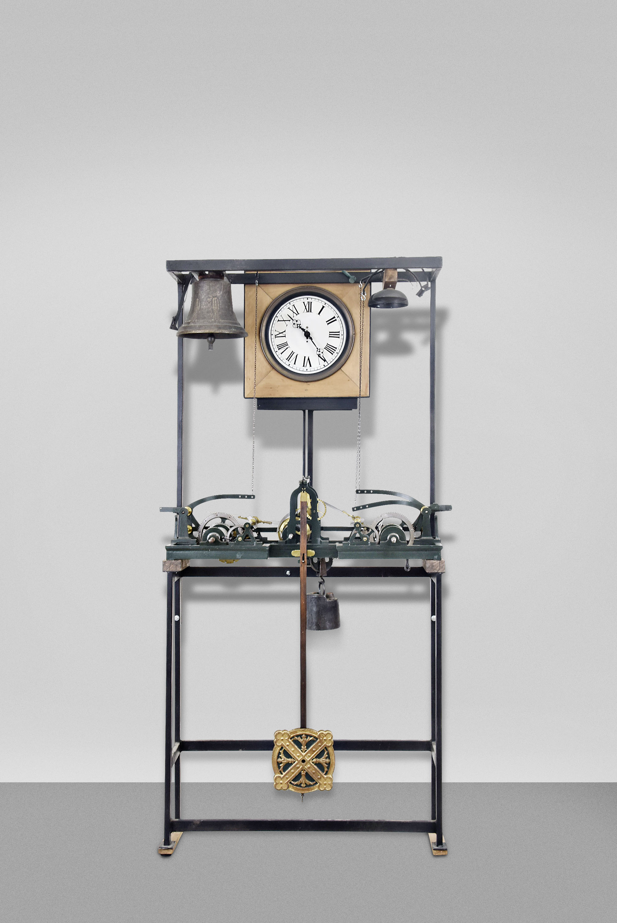 Europe, tower clock, time, strike and chime, three train movement with pinwheel escapement in a green painted cast iron frame with decorative pendulum bob now arranged in a custom stand and frame with bells and dial to operate in a standard room. Nameplate attached to frame is engraved "PAUL GARNIER Horloger Mecanicien 6&amp;17 Rue Taitbour Paris ". — Antique Clocks Price Guide