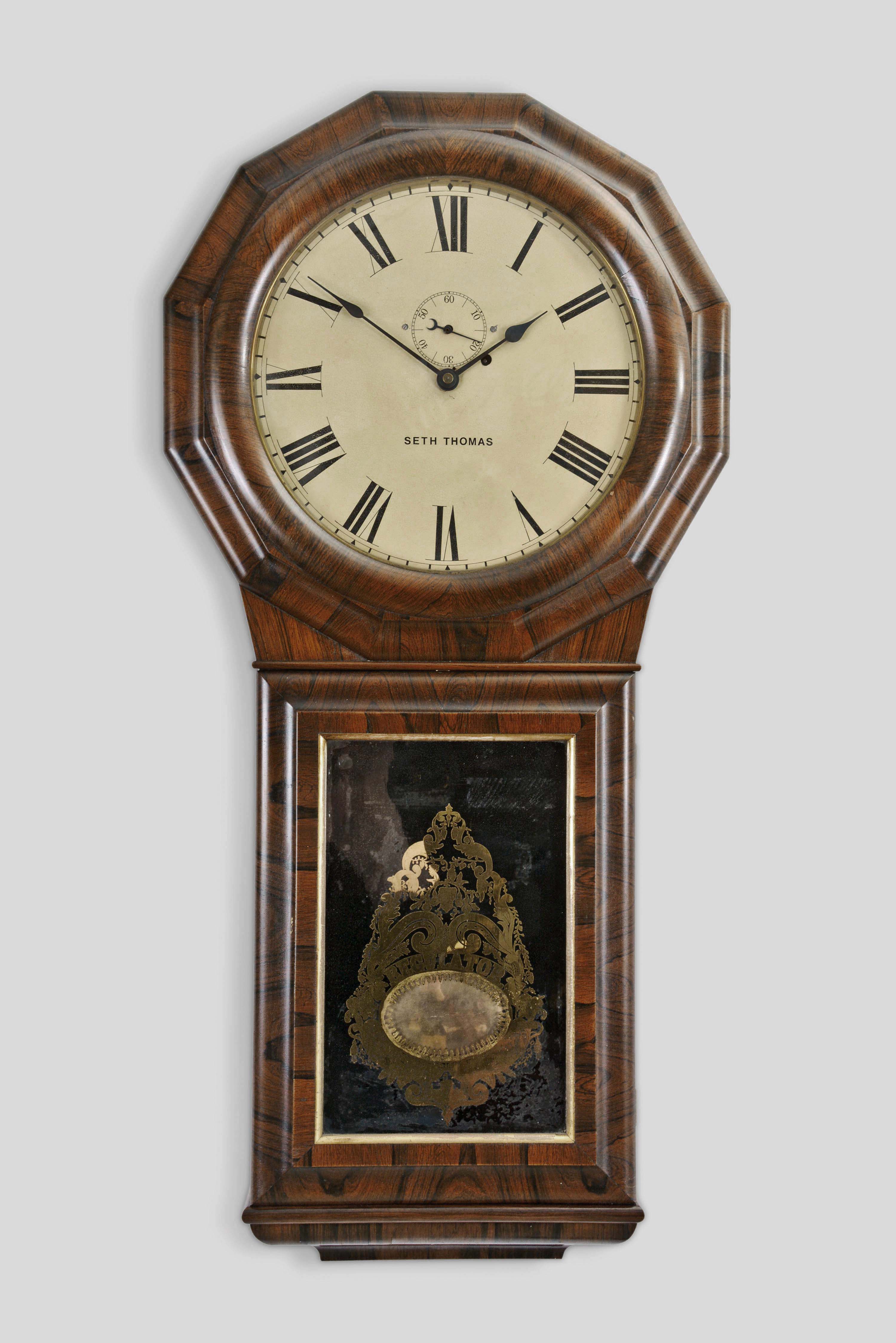 Seth Thomas Clock Co., Thomaston, Conn., "Regulator No. 1 Extra" hanging clock with a round plate, weight driven, 8 day, S. B. Terry style timepiece movement in a rosewood veneered case. — Antique Clocks Price Guide