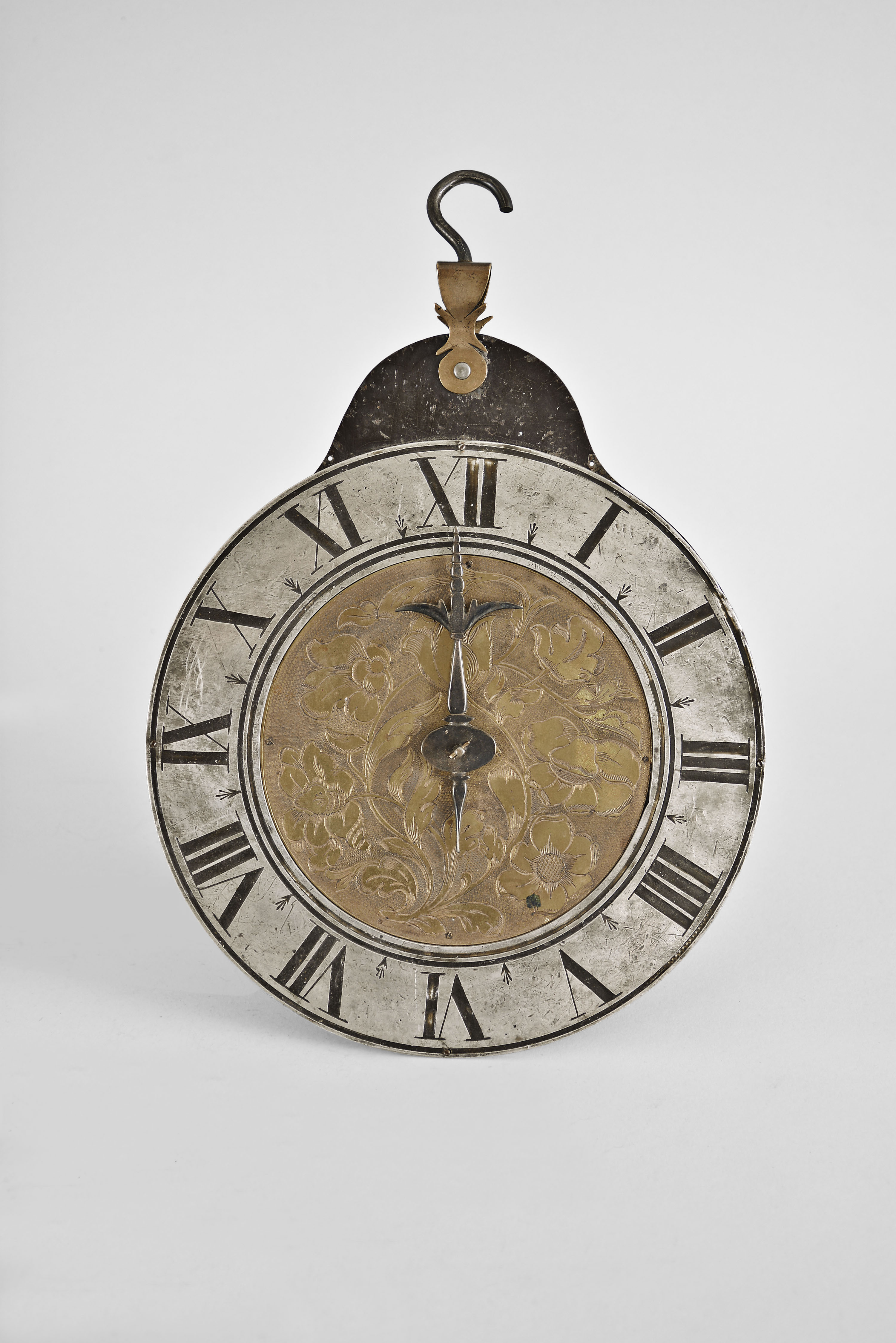 Telleruhr, roman numeral pewter dial with engraved brass center, mounted to a sheet iron backplate, with brass and iron hanger, the movement contained in a cylindrical, footed case, fastened by screws to the dial, the bottom hinged and with pivoted catch, and containing a thirty hour, verge fusee movement signed "Johannes Buschman Junger Augspurg", asymmetrical pierced and engraved balance cock, steel balance with hog bristle regulation, pierced and engraved fusee set up click with decorative blued steel spring — Antique Clocks Price Guide