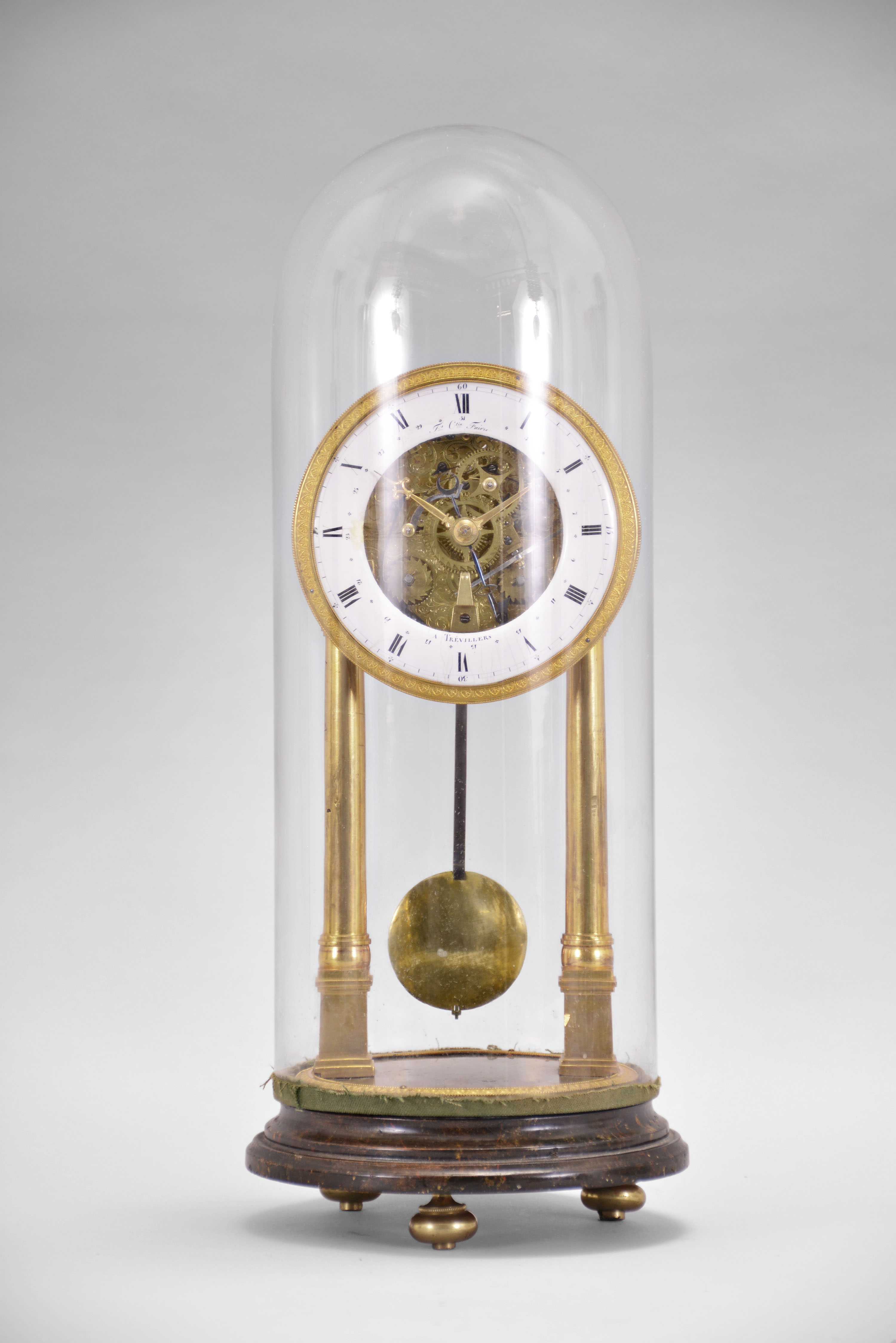 Faivre, a Trevillers, an unusual 8 day, quarter striking skeleton clock with calendar, the clock supported by two gilt columns on square plinths, roman numeral white enamel dial with gilt, palmette ornamented bezel, and date display within the Roman chapter, fancy gilt hands with blued steel date hand, two train, quarter striking movement, the upper half of the front plate with pierced and engraved acanthus leaf ornament, the lower half with acanthus engraving, strike work mounted to the back plate, the quarters sounding on two bells, pendulum with steel rod and brass bob, all resting on a faux marble, turned base with brass feet and dome — Antique Clocks Price Guide