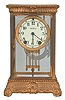 Seth Thomas Clock Co., Thomaston, Conn., "Empire No. 13" crystal regulator, 8 day, time and strike, round spring-driven movement with rack and snail strike in a gilt brass case with beveled glass front, sides, and back with a white porcelain dial and blued steel hands.