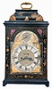 John Halifax, London a late 18th century japanned bracket clock, composite brass arch dial, silvered roman numeral chapter ring signed below 6:00, "John Halifax/London", date aperture and mock pendulum, regulation dial in the arch, blued steel hands, matted centers and brass spandrels, the molded top case with japanned decoration of a Chinese pagoda and brass carrying handle at the top, dial door with floral decoration and pierced sound frets and sides both backed with red fabric, all resting on short bracket feet, the rear glazed door opens to the eight day, cable fusee, verge escapement movement with rack striking on the hour, back plate fully engraved with centered woman playing a violin, rise and fall pendulum with small brass bob and pendulum holder.